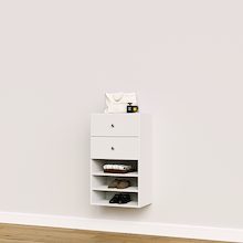 White closet drawer unit with slab fronts and shelves for folded clothes and wardrobe storage.