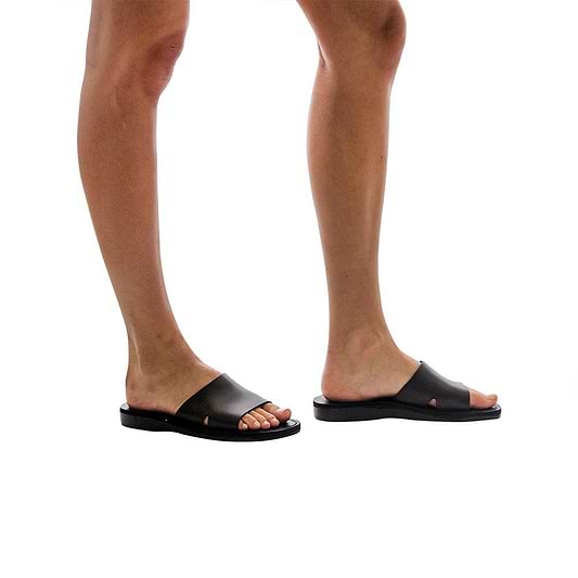 Model wearing Bashan black, handmade leather slide sandals