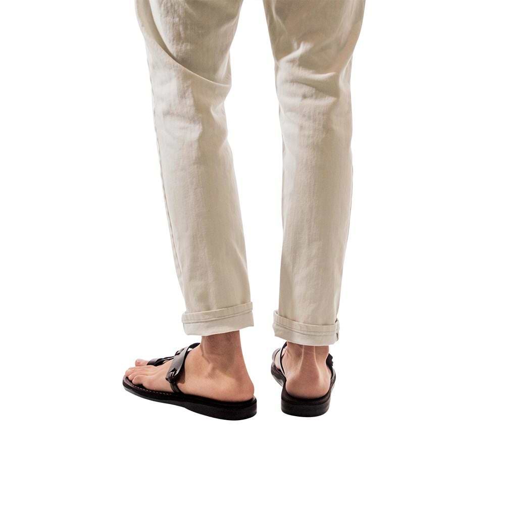 Model wearing David brown, handmade leather slide sandals with toe loop