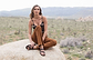 a female model sitting on a rock wearing Jerusalem sandals