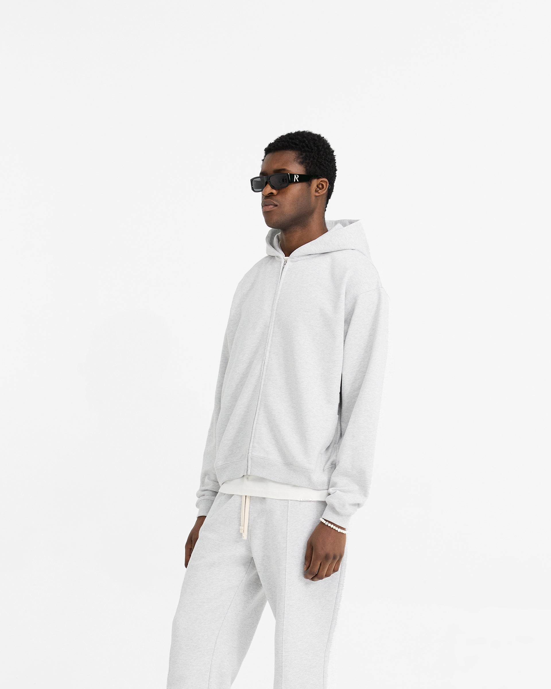 Back product image of a mens grey zip hoodie on a plain white background | Initial Oversized Zip Hoodie in Ice Grey Marl | Zip hoodie with oversized fit and embroidered initial | Initial Hoodies | Represent Clo