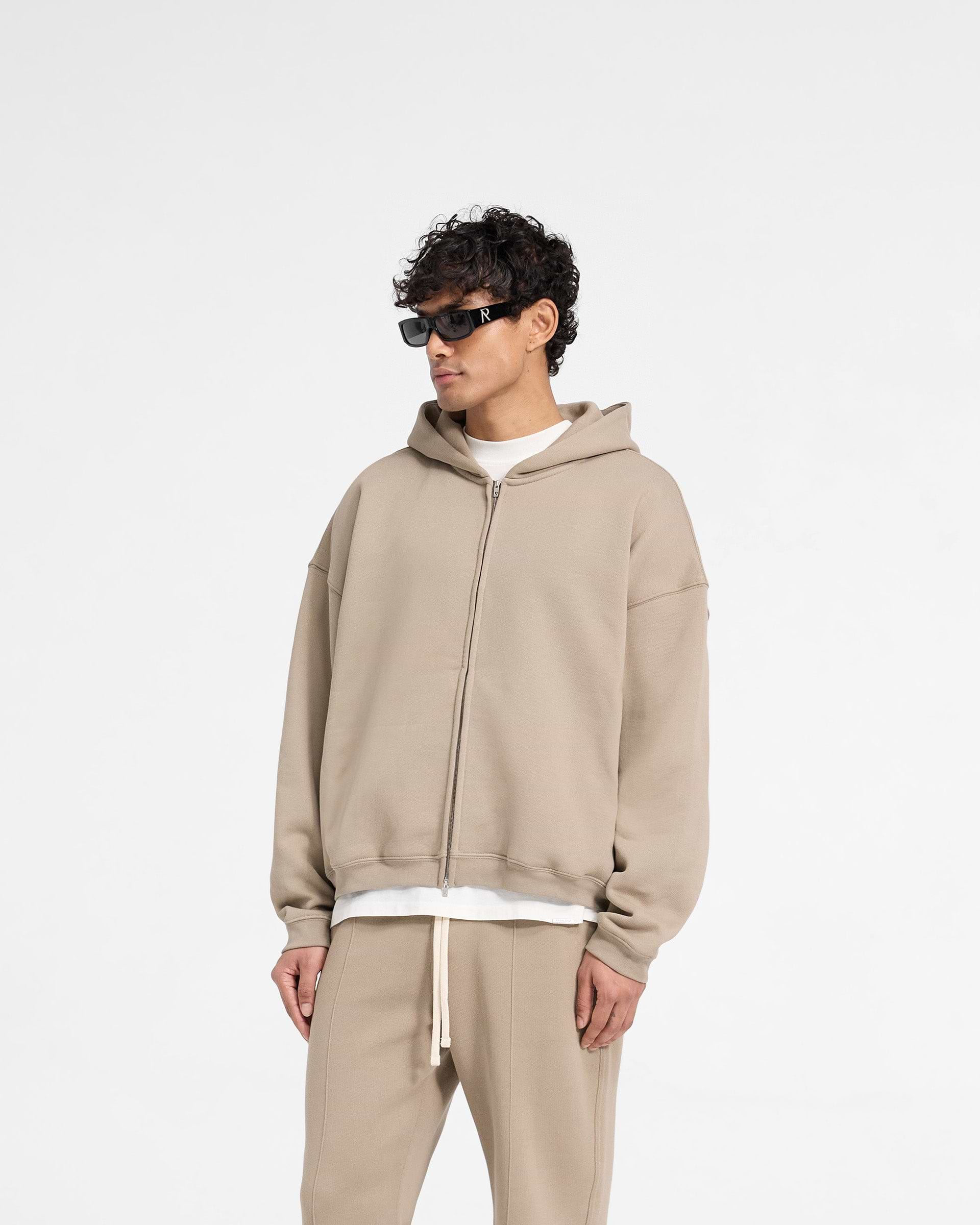 Back product image of a mens beige hoodie on a plain white background | Initial Boxy Zip Through Hoodie in Dune | Oversized boxy fit hoodie with brushed fleeceback cotton | Initial Hoodies | Represent Clo