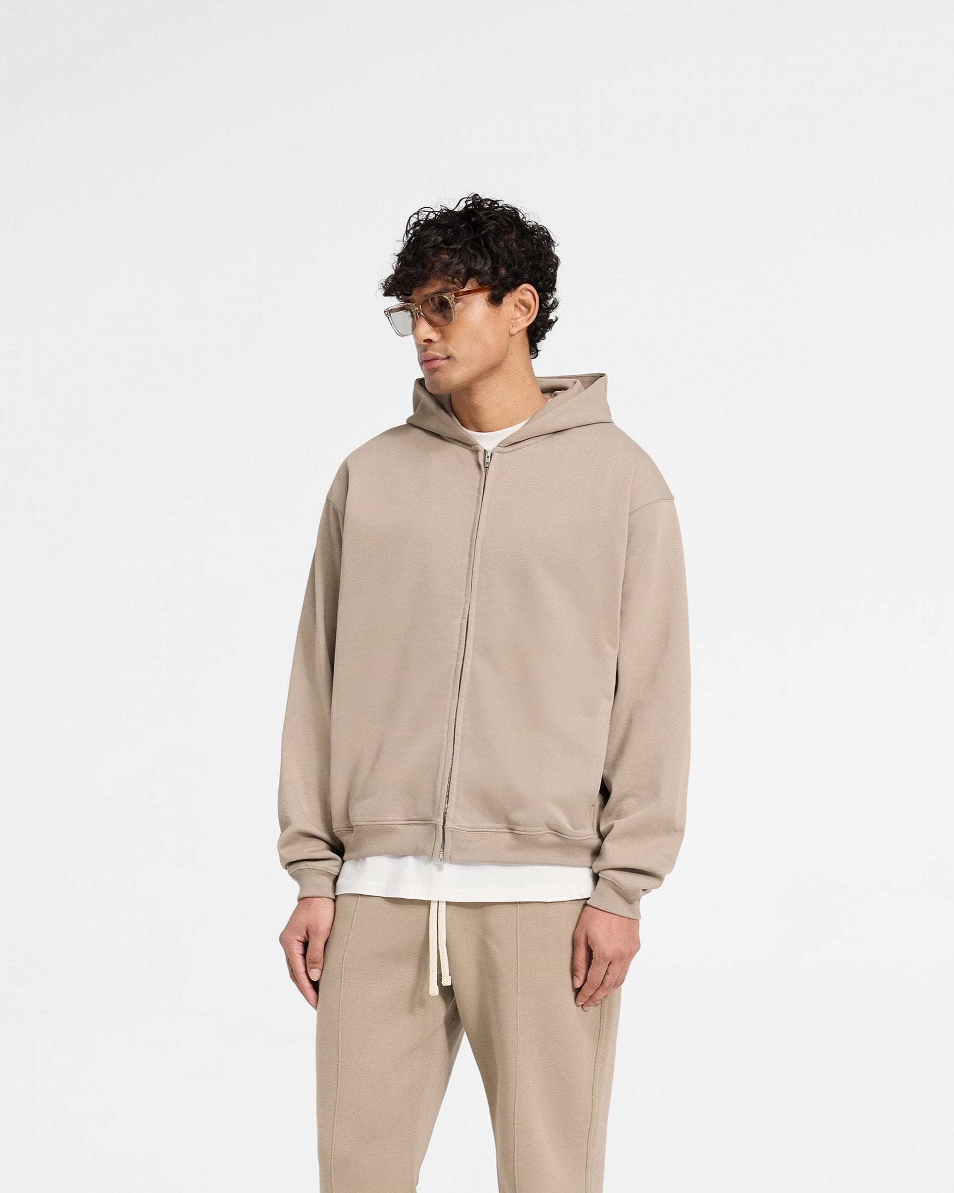 Back product image of a mens dune zip hoodie on a plain white background | Initial Zip Hoodie in Dune | Oversized hoodie with welted pockets and double zip | Initial Hoodies | Represent Clo