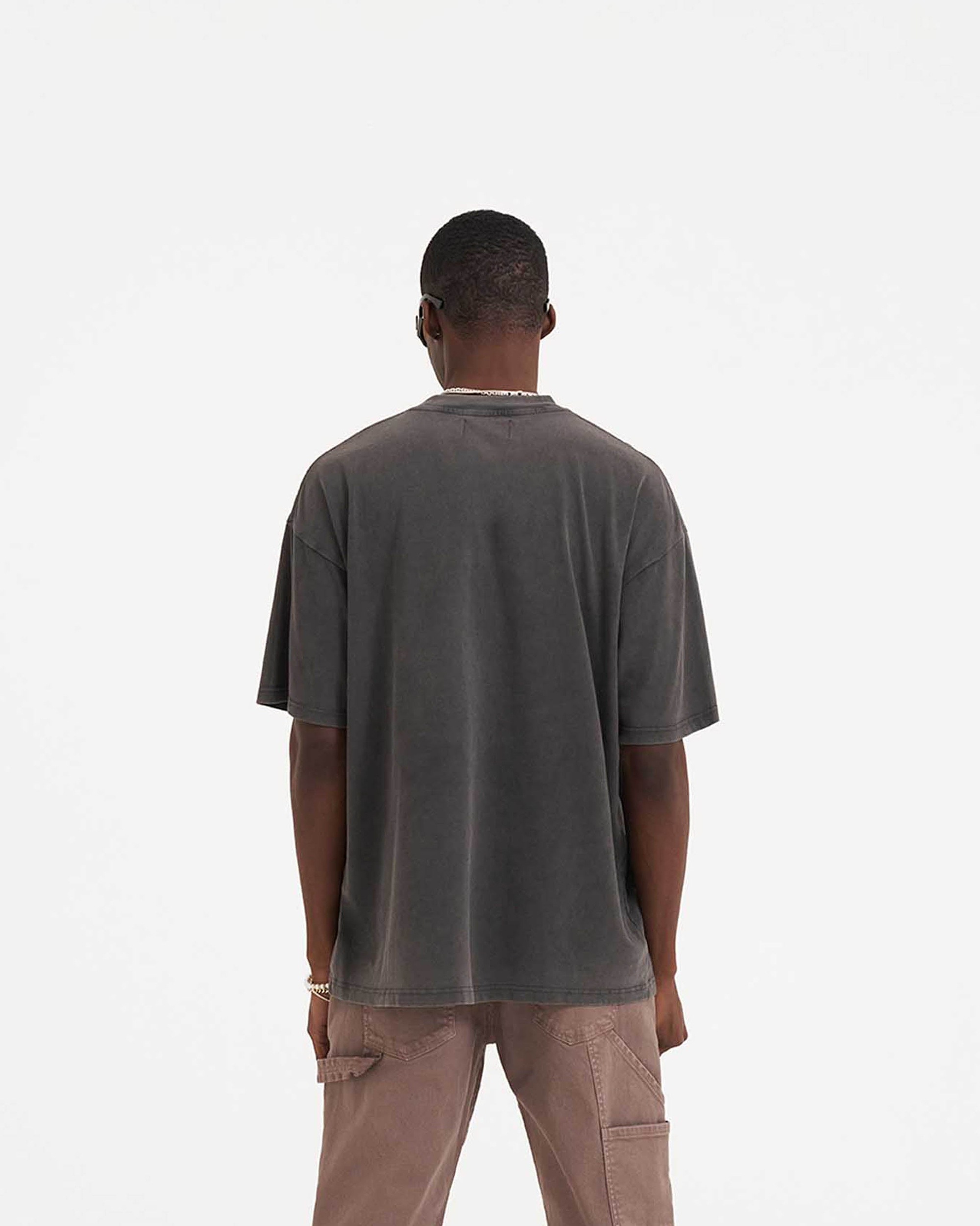 Man wearing a grey graphic t-shirt on a plain white background | Shark Jaws T-Shirt in Vintage Grey | Oversized fit short sleeve t-shirt with screen printed graphic | SS23 T-Shirts | Represent Clo