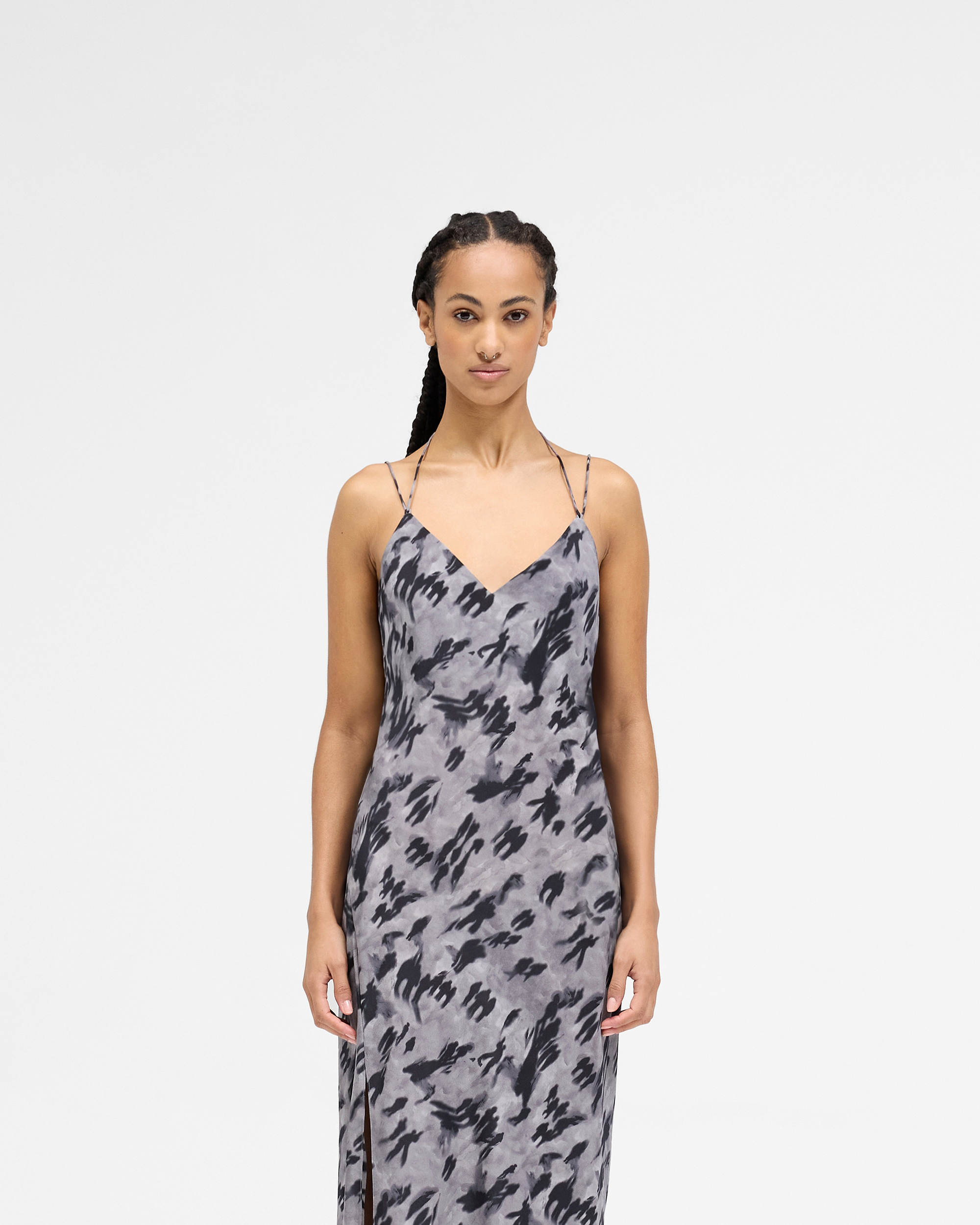 Woman wearing a dark scenic print slip dress on a plain white background | Street Shadow Dress in Dark Scenic Print | Silk slip dress with adjustable straps and thigh split | Womens SS25 Dresses | Represent Clo