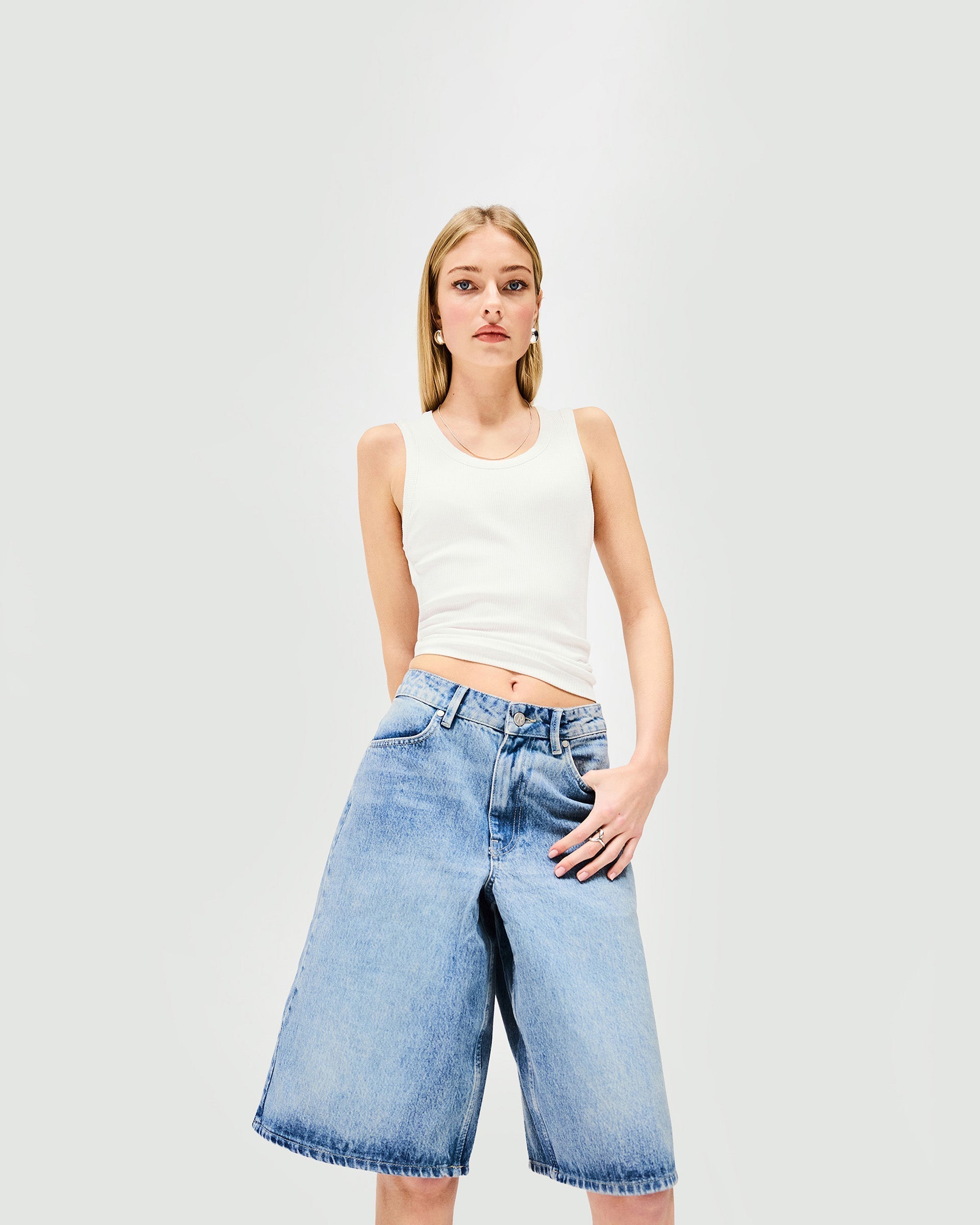 Back product image of womens blue denim shorts on a plain white background | Denim Bermuda Short in Washed Blue | Denim shorts designed to flatter body shape | Womens SS25 Denim | Represent Clo
