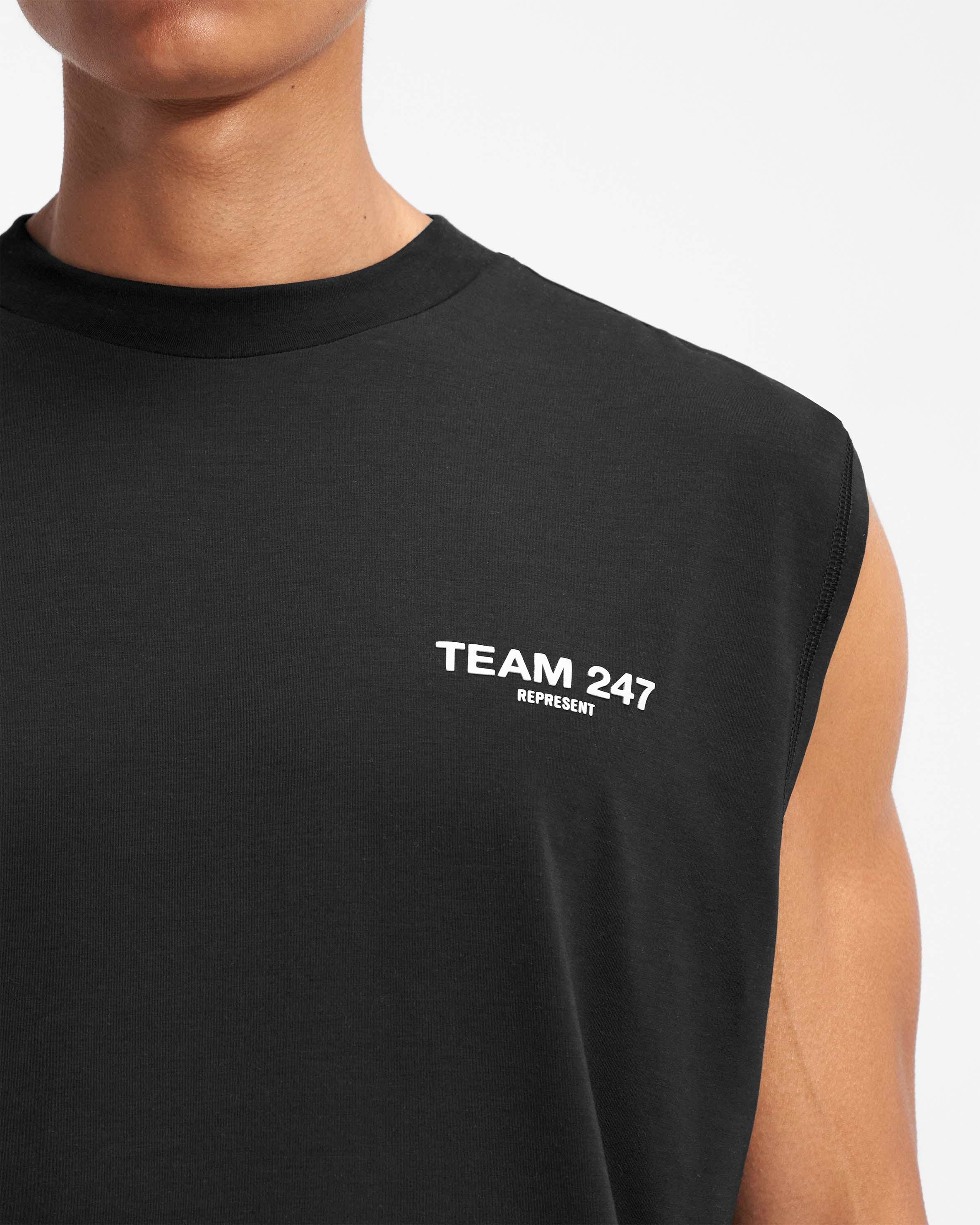 Man wearing a black oversized tank on a plain white background | Team 247 Oversized Tank in Black | Oversized tank top with 4-way stretch and breathable fabric | 247 T-Shirts | Represent Clo