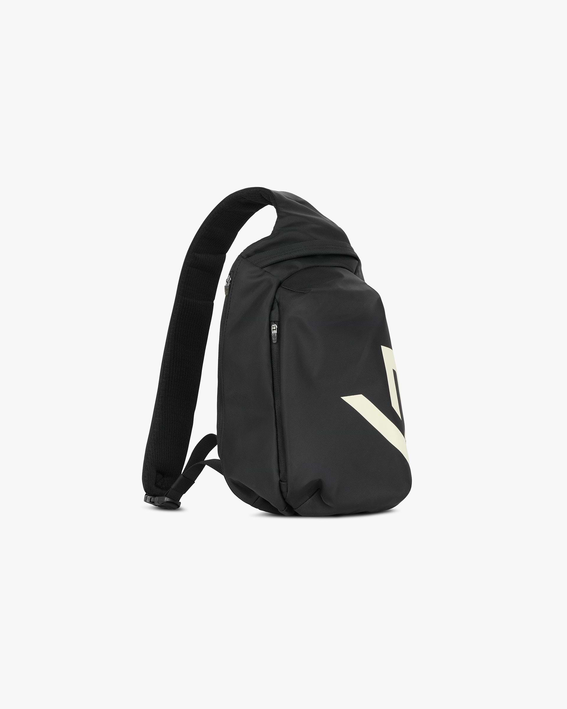 Back product image of a mens black sling bag on a plain white background | 247 Sling Bag in Black | Sling bag with 2 zip pockets and adjustable padded strap | 247 Accessories | Represent Clo