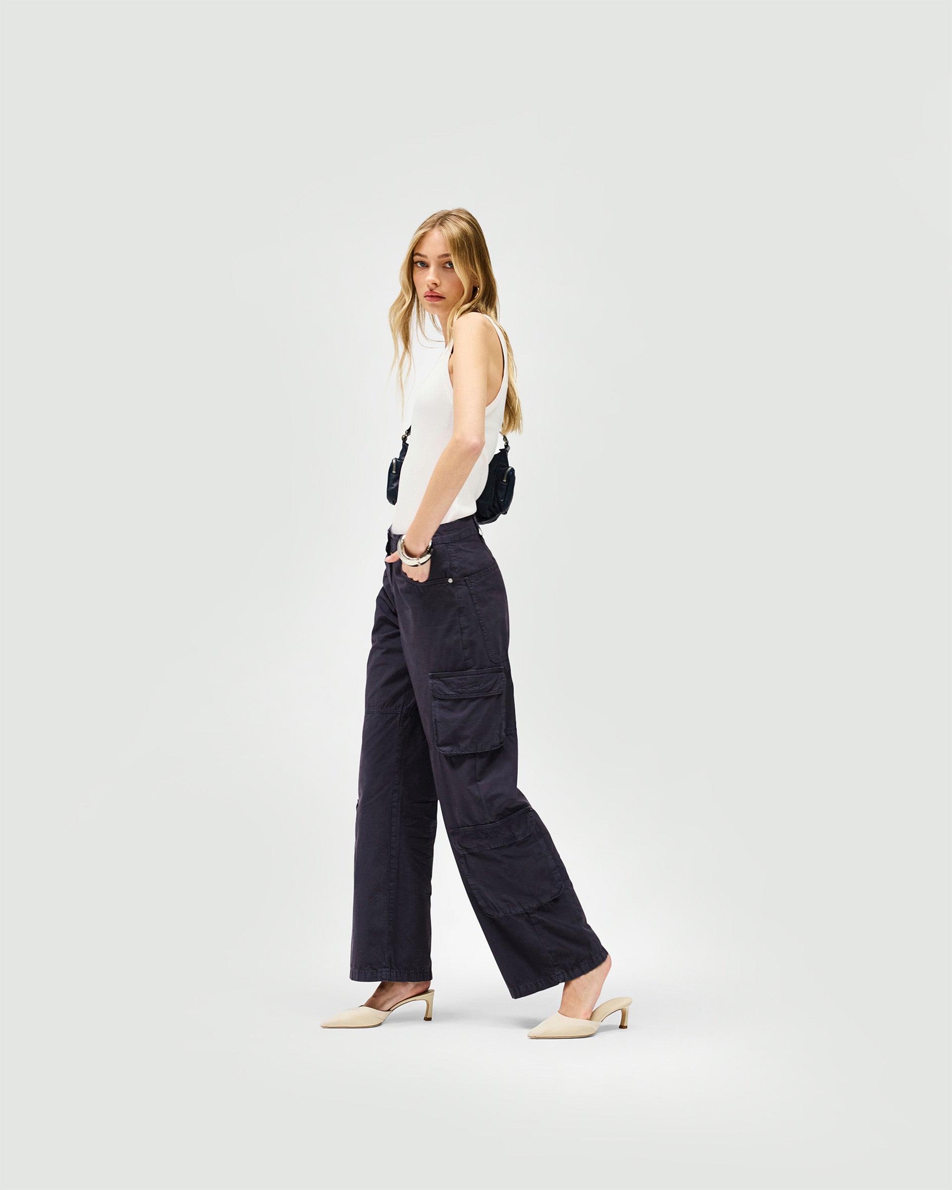 Back product image of a womens blue cargo pants on a plain white background | Fender Cargo in Steel Blue | Trousers with cargo pockets and wide-leg silhouette | Womens SS25 Bottoms | Represent Clo