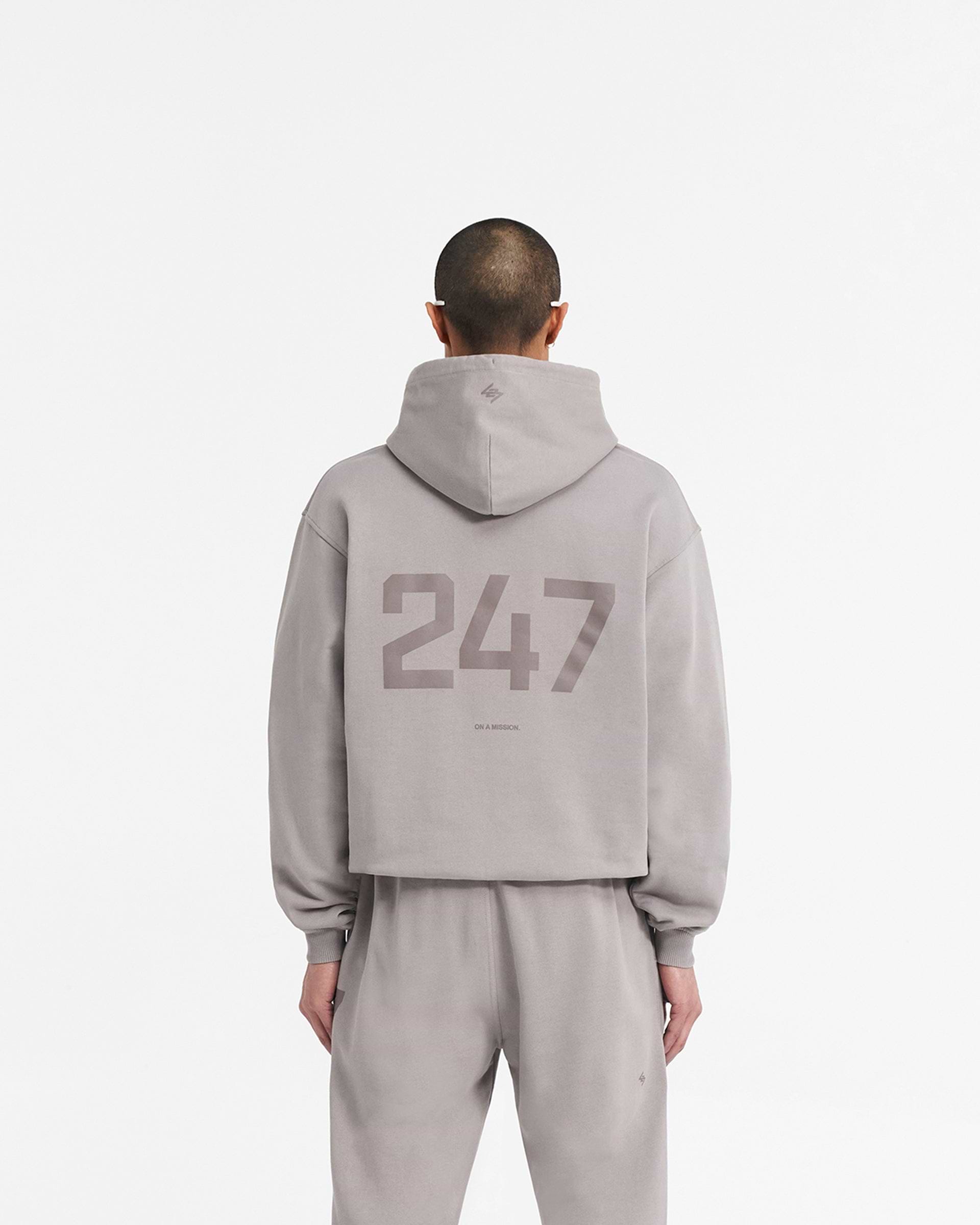 Man wearing an oversized grey hoodie on a plain white background | 247 Oversized Hoodie in Cinder | Oversized hoodie with ribbed cuffs and hem | 247 Hoodies | Represent Clo