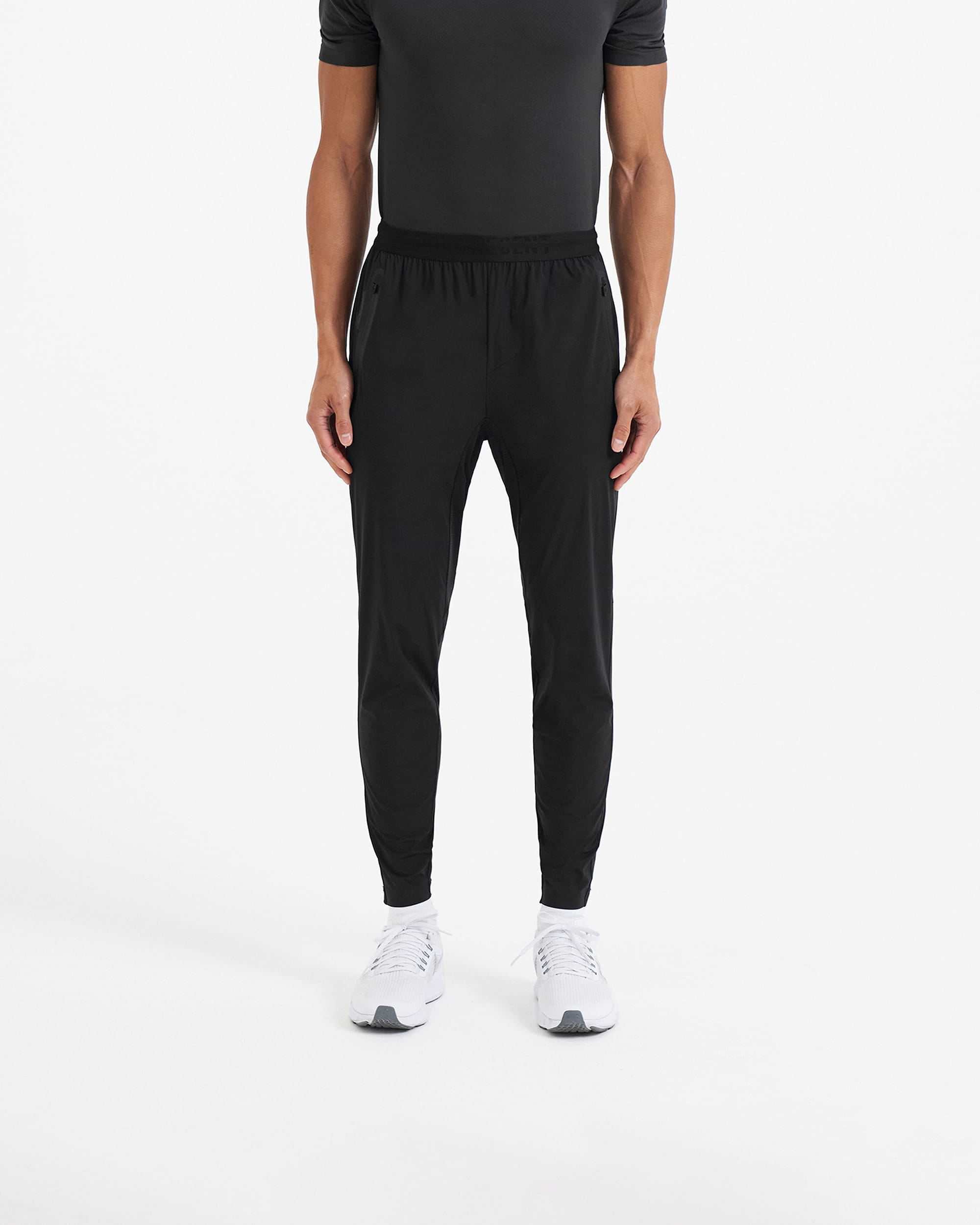Back product image of mens black joggers on a plain white background | 247 Active Jogger in Black | Running pants with 4-way stretch and zip pockets | 247 Pants | Represent Clo