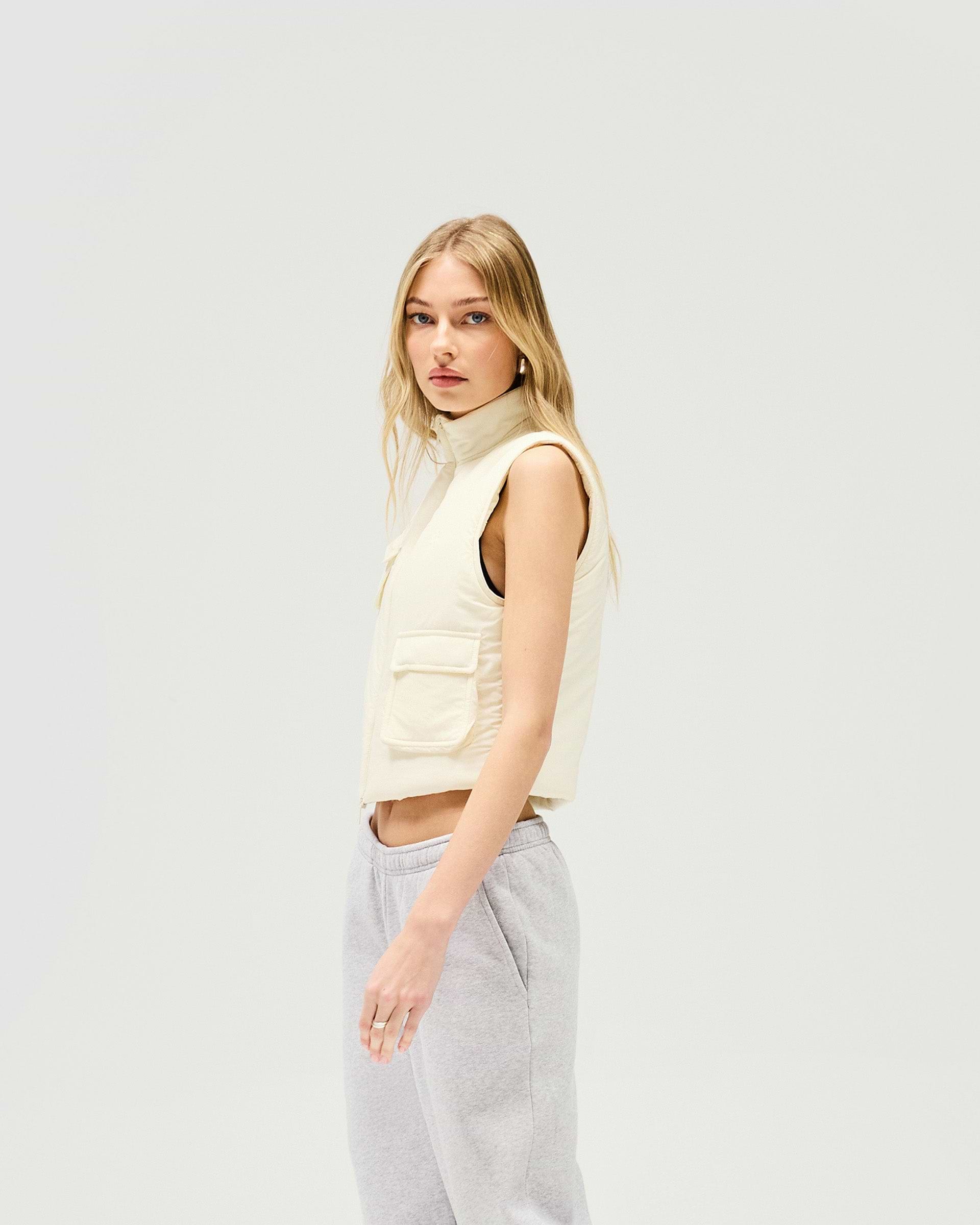 Back product image of a womens white gilet on a plain white background | Revolver Gilet in Warm White | Shrunken fit gilet with recycled down fill | SS25 Outerwear | Represent Clo