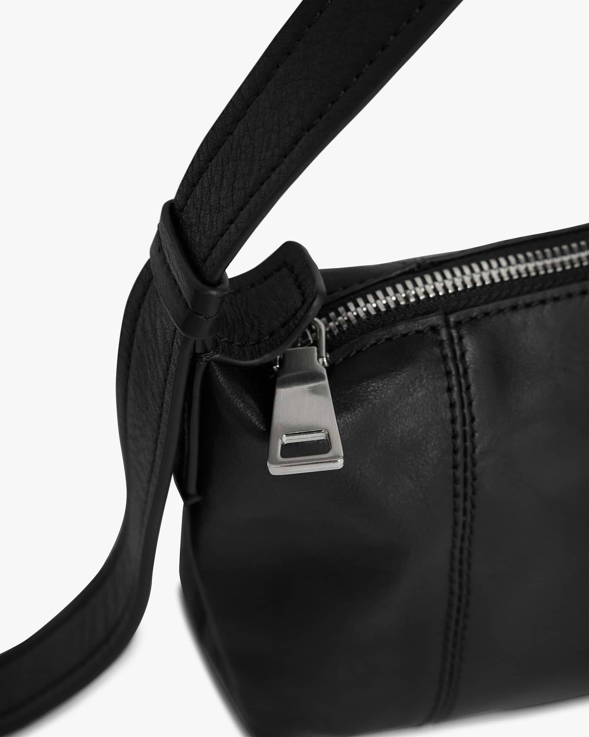 Back product image of a womens black baguette bag on a plain white background | Snap Baguette Bag in Jet Black | Baguette bag with zip fastening and adjustable strap | Womens SS25 Accessories | Represent Clo