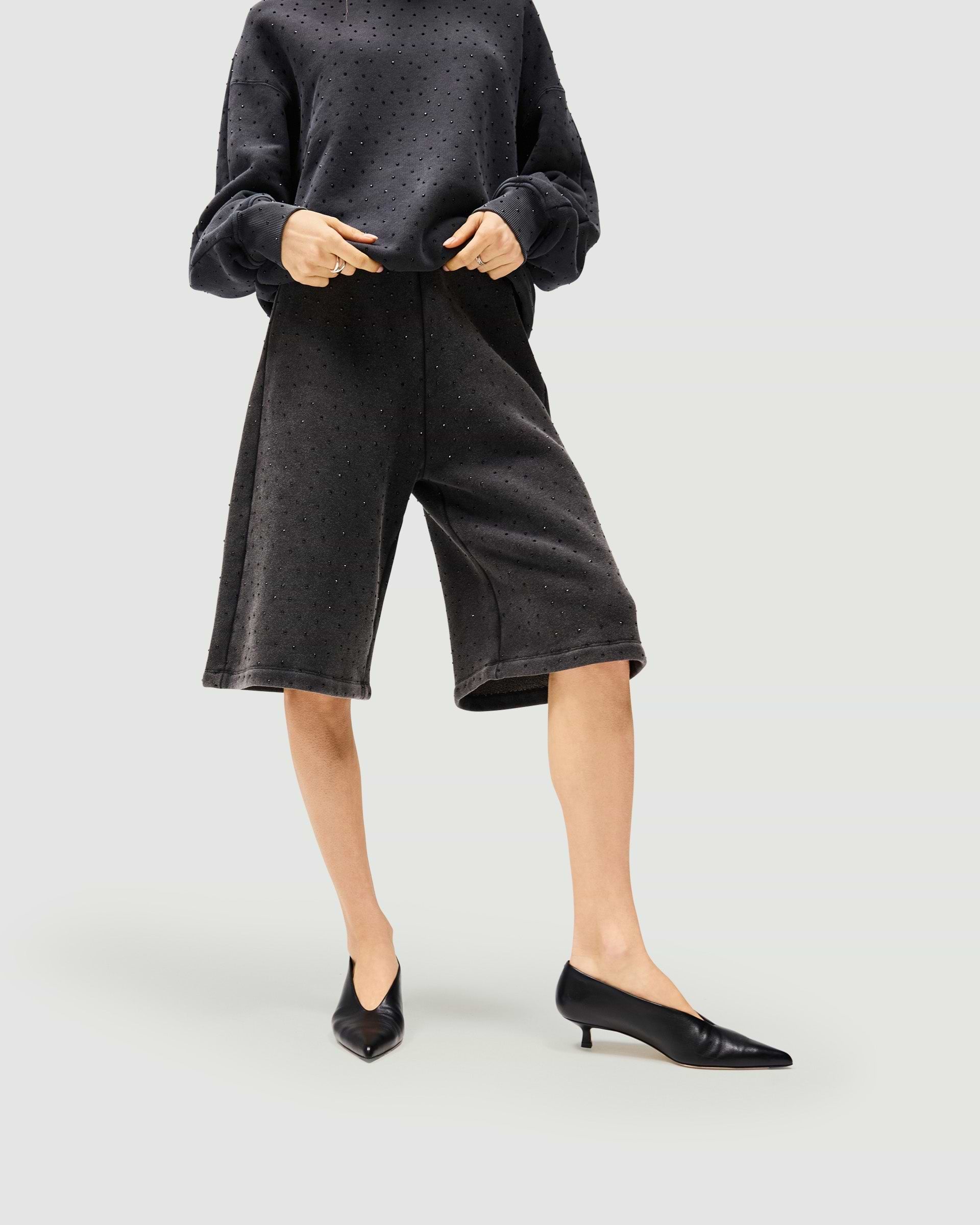 Back product image of womens grey leather shorts on a plain white background | Spark Shorts in Washed Grey | Leather shorts with elasticated waist and wide-leg fit | Womens SS25 Shorts | Represent Clo