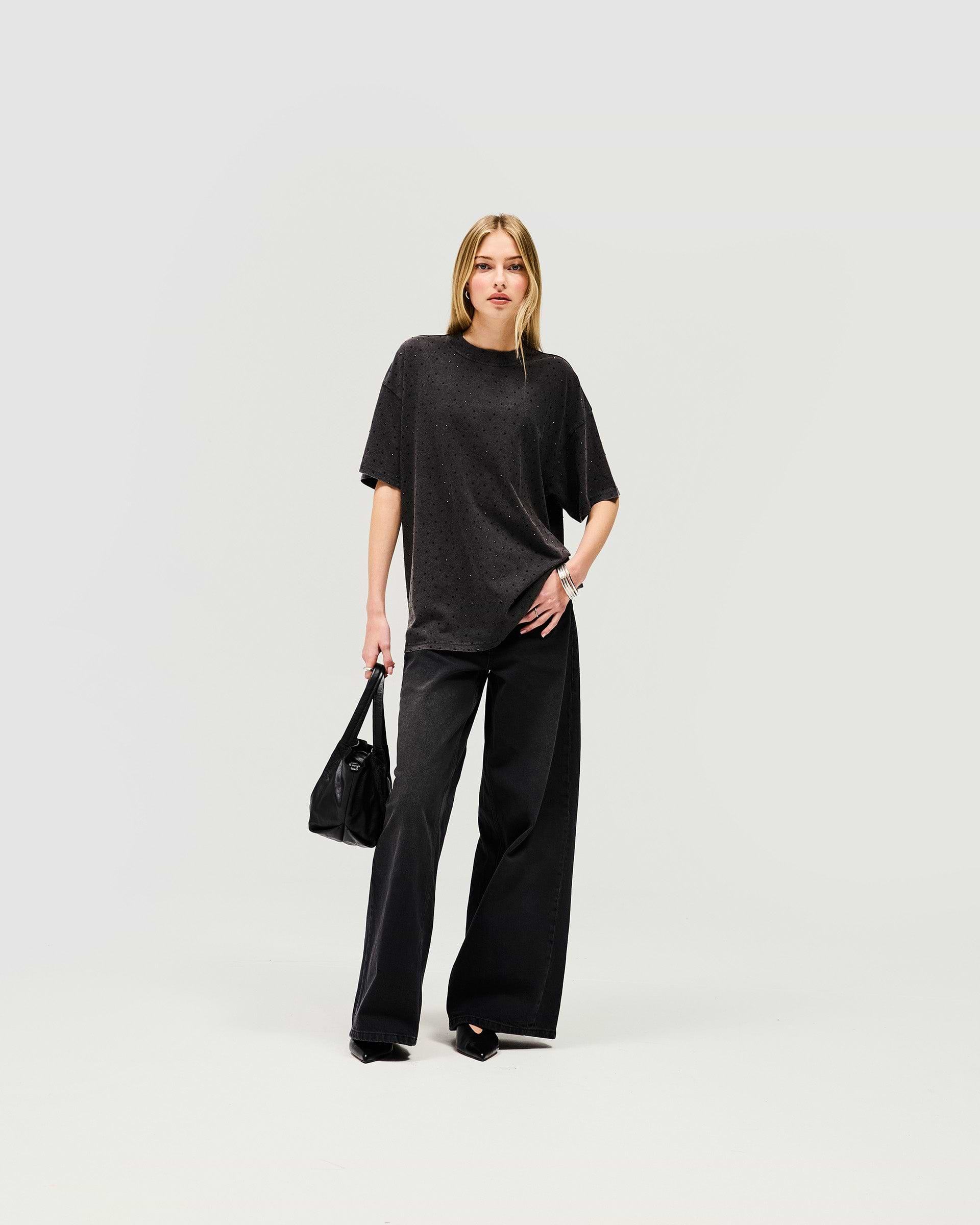 Woman wearing an oversized grey t-shirt on a plain white background | Spark T-Shirt in Washed Grey | Oversized t-shirt with soft acid wash and hot fix detail | Womens SS25 Tops | Represent Clo