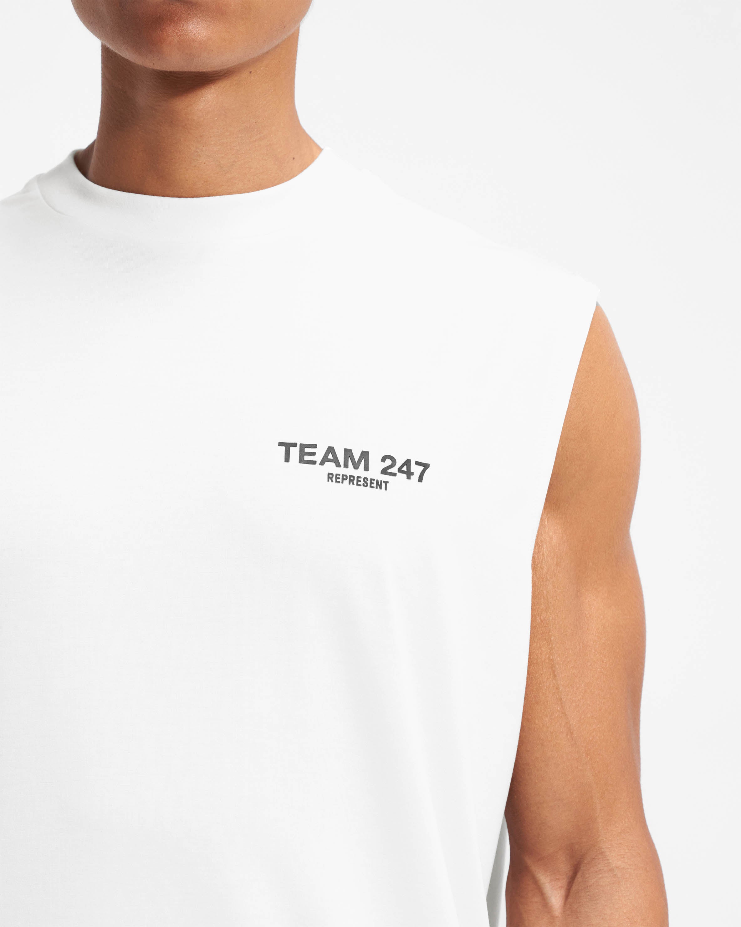 Man wearing a white oversized tank top on a plain white background | Team 247 Oversized Tank in Flat White | Tank top with 4-way stretch | 247 T-Shirts | Represent Clo
