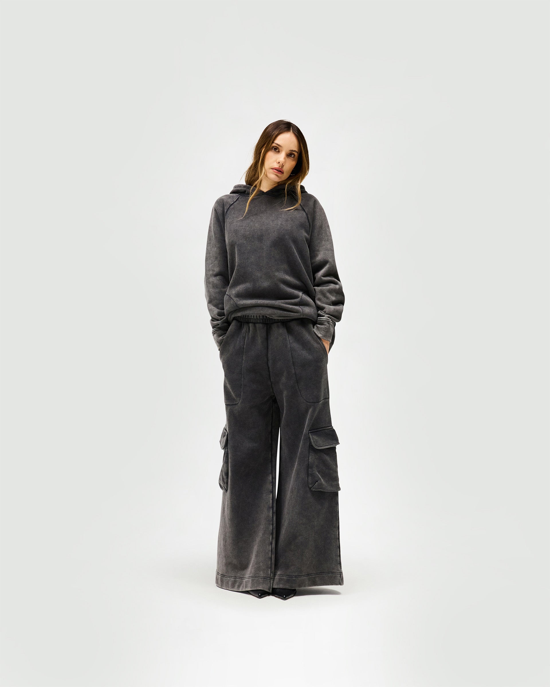 Woman wearing oversized charcoal sweatpants on a plain white background | Monster Sweatpant in Charcoal | Oversized sweatpants with elasticated waist and wide leg | Womens SS25 Bottoms | Represent Clo