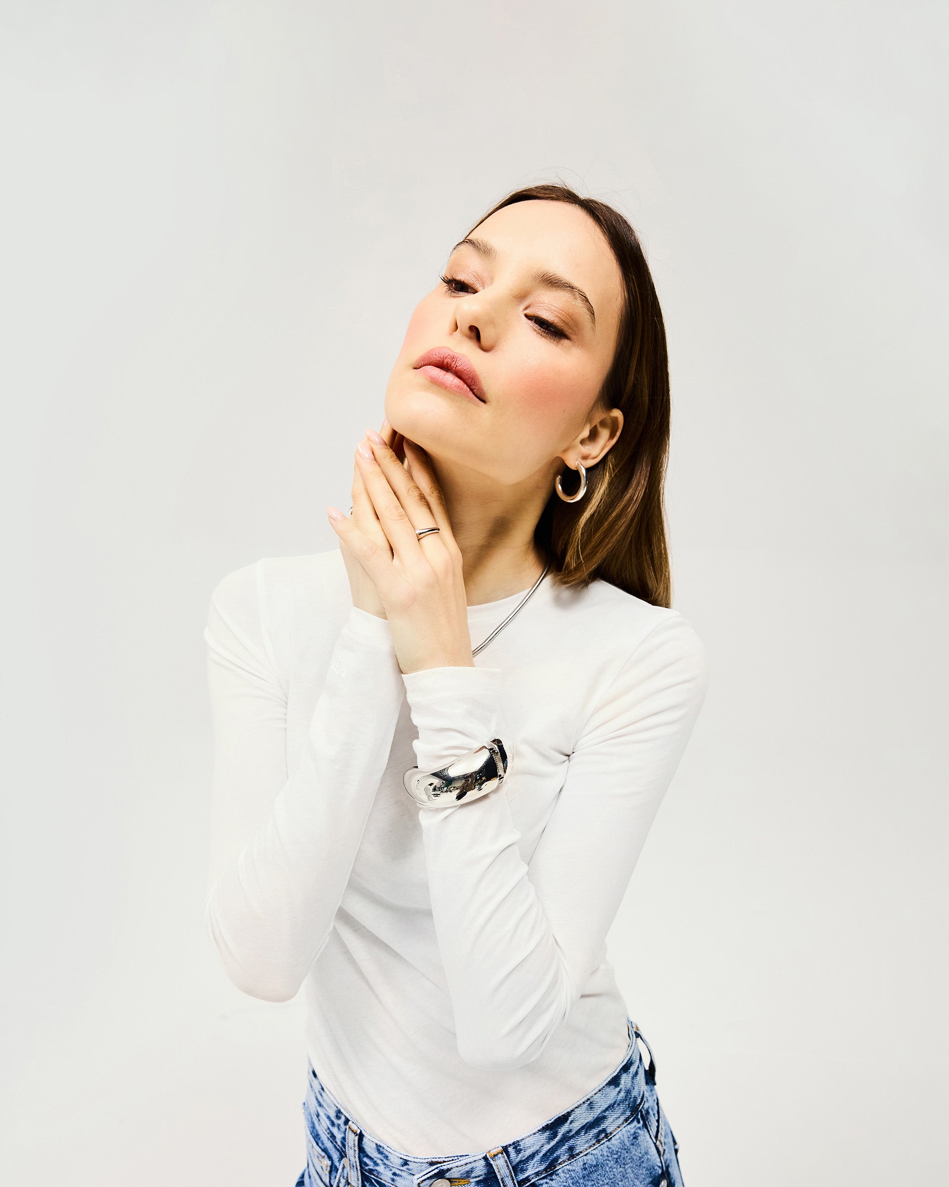 Back product image of a womens cream long sleeve top on a plain white background | Trigger Long Sleeve in Cream | Superfine cotton knitwear with slightly sheer finish | Womens SS25 Knitwear | Represent Clo
