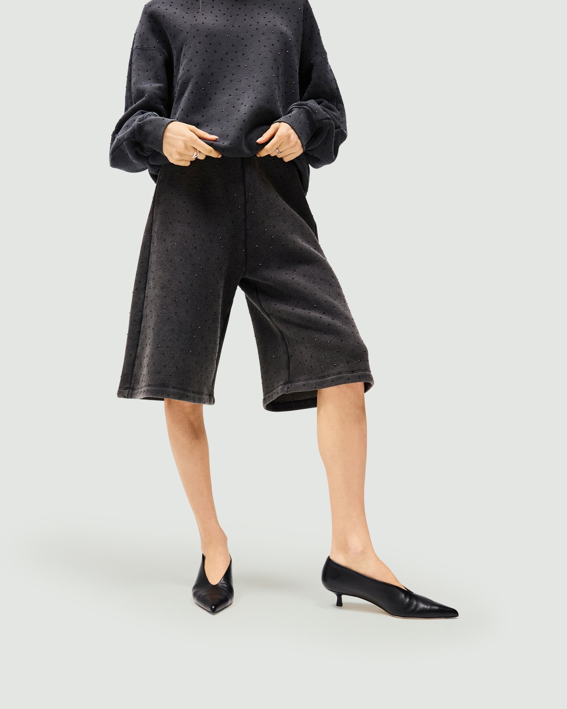 Back product image of womens grey leather shorts on a plain white background | Spark Shorts in Washed Grey | Leather shorts with elasticated waist and wide-leg fit | Womens SS25 Shorts | Represent Clo
