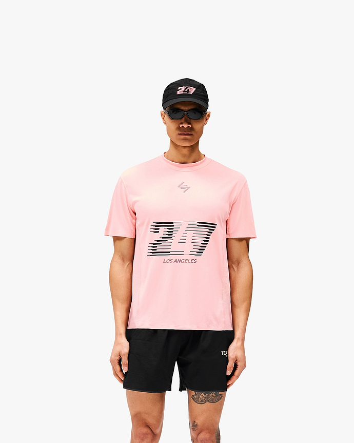 Man wearing a pink t-shirt on a plain white background | 247 Los Angeles T-Shirt in Pink | Lightweight sweat-wicking t-shirt with honeycomb mesh panelling | 247 T-Shirts | Represent Clo