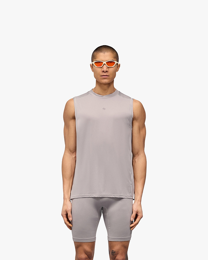 Man wearing a grey technical tank top on a plain white background | 247 Contour Run Tank in Titanium | Breathable and sweat-wicking running tank | 247 T-Shirts | Represent Clo