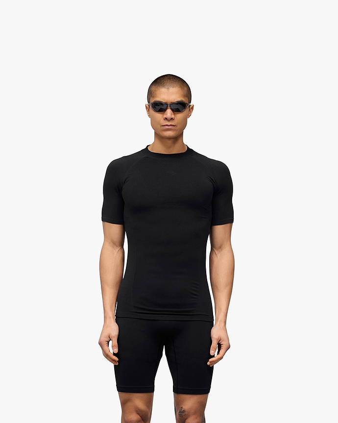 Man wearing a black t-shirt on a plain white background | 247 DNA Seamless T-Shirt in Black | Seamless t-shirt for optimal breathability and mobility | 247 T-Shirts | Represent Clo