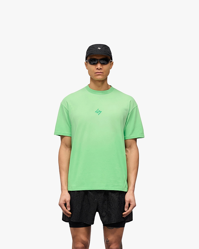 Man wearing an oversized green t-shirt on a plain white background | 247 Motion Oversized T-Shirt in Speed Green | T-Shirt with sweat wicking capability and fade out wash | 247 T-Shirts | Represent Clo