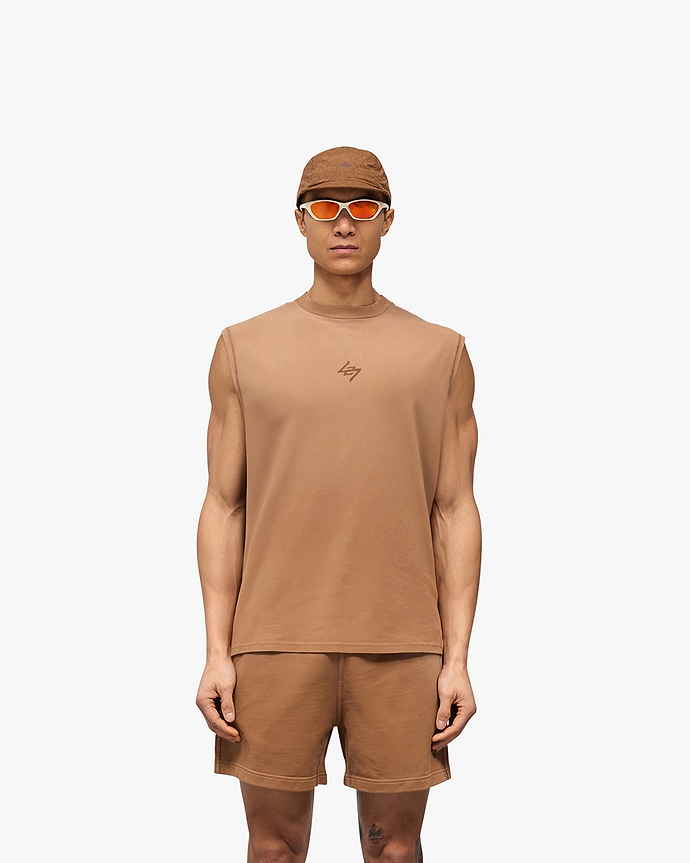 Man wearing an oversized rust tank top on a plain white background | 247 Motion Oversized Tank in Rust | Oversized tank with 2 way stretch and sweat wicking | 247 T-Shirts | Represent Clo