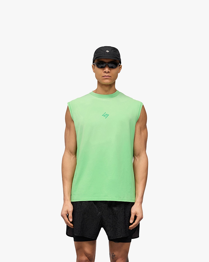 Man wearing a green oversized tank on a plain white background | 247 Motion Oversized Tank in Speed Green | Stretch cotton tank with graphic print | 247 T-Shirts | Represent Clo