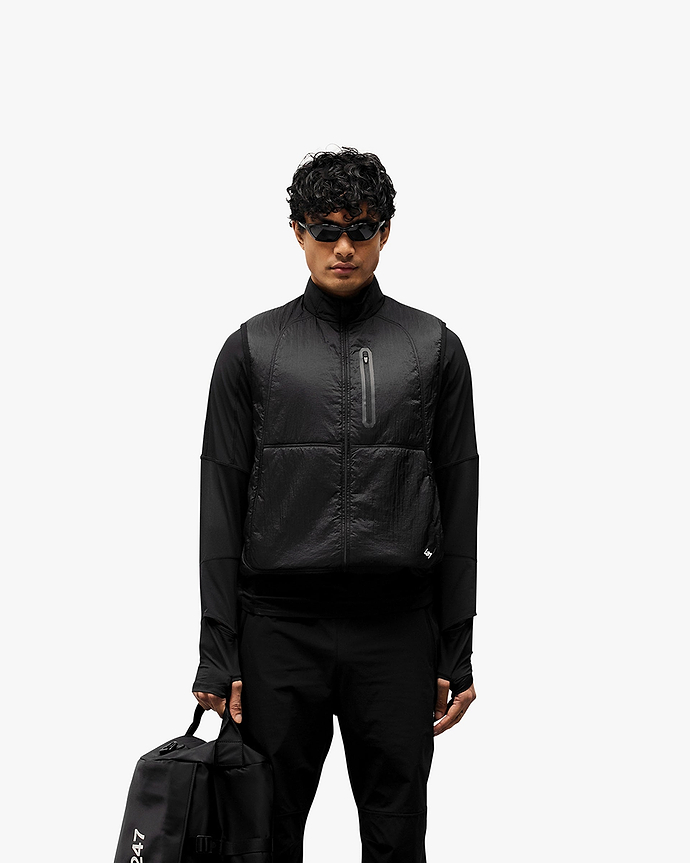 Man wearing a black running gilet on a plain white background | 247 Run Gilet in Black | Running gilet with insulation and zip pockets | 247 Outerwear | Represent Clo