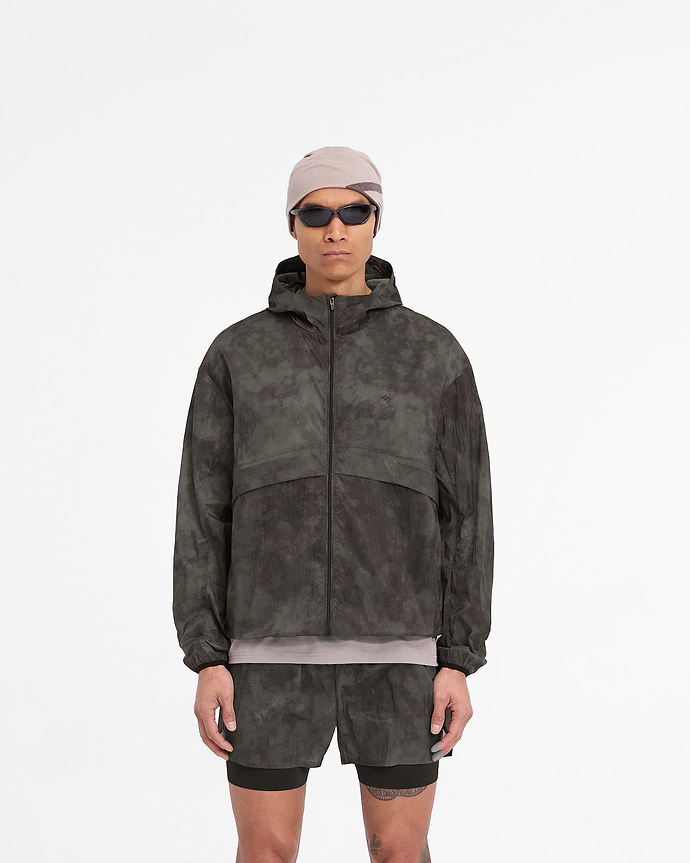 Man wearing a terrain hooded jacket on a plain white background | 247 Hooded Training Jacket in Terrain | Nylon training jacket with DWR coating | 247 Outerwear | Represent Clo