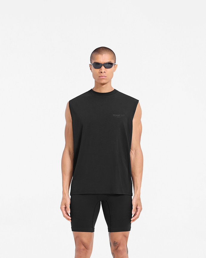 Man wearing a black oversized tank on a plain white background | Team 247 Oversized Tank in Matte Black | Lightweight breathable tank top with 4-way stretch | 247 T-Shirts | Represent Clo