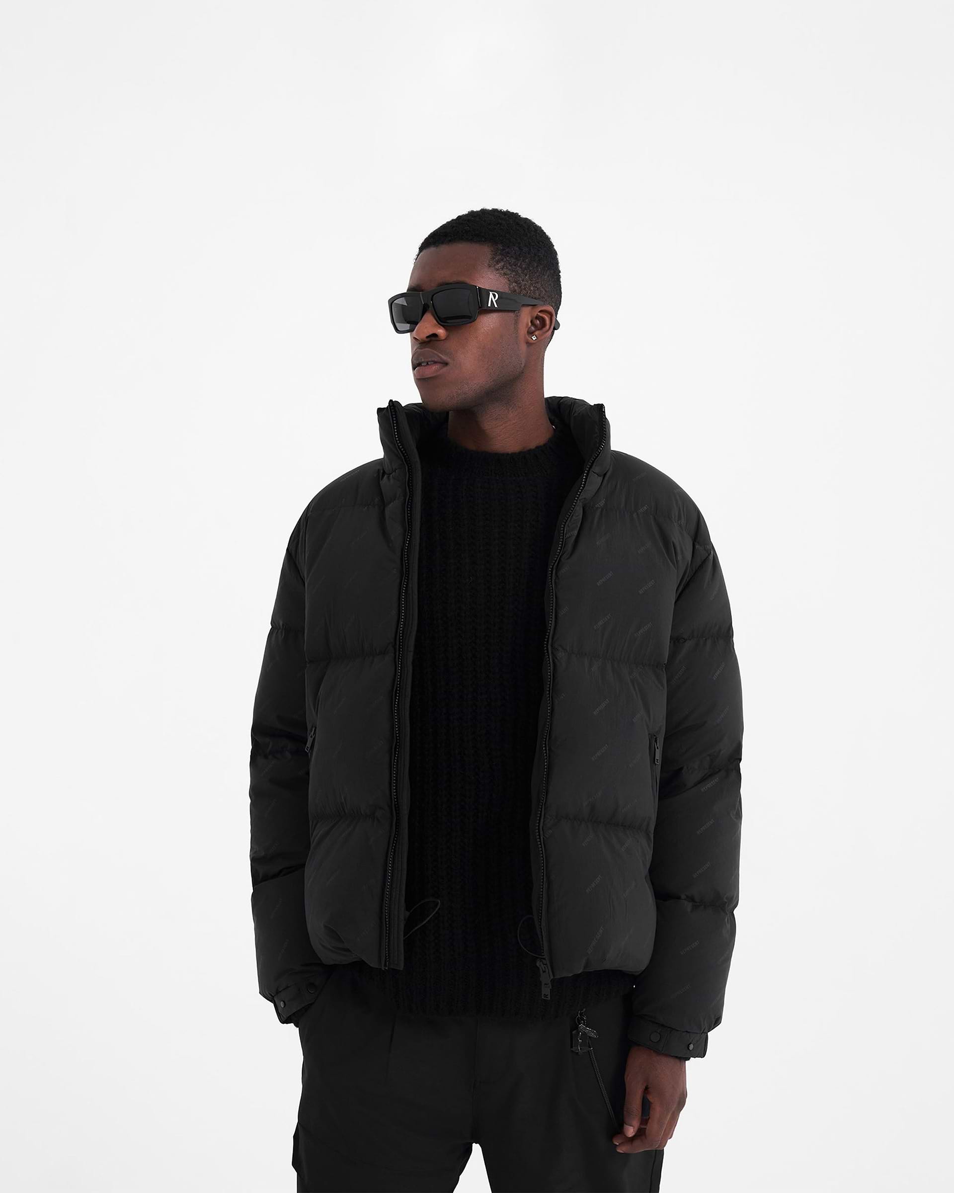 All Over Logo Puffer Jacket | Black Outerwear FW22 | Represent Clo