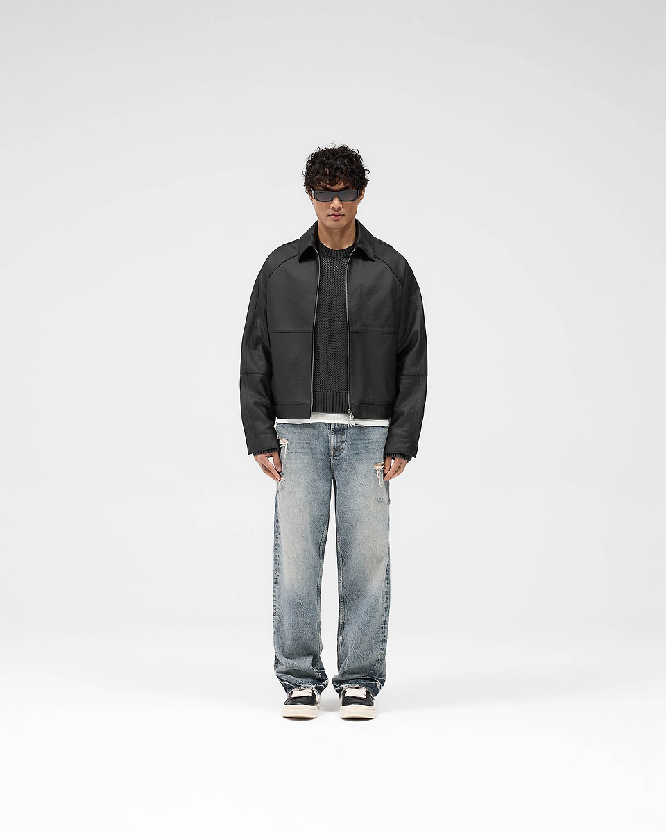 Man wearing a black leather jacket on a plain white background | Overdrive Leather Jacket in Black | Oversized leather jacket with structured sleeves | SS25 Outerwear | Represent Clo