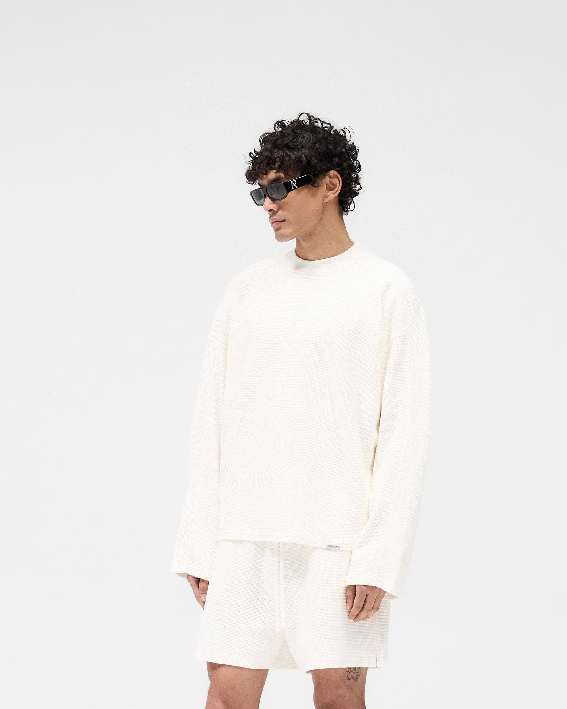 Back product image of a mens white shirt on a plain white background | Waffle Long Sleeve T-Shirt in Flat White | Long sleeve shirt in waffle fabric | SS25 T-Shirts | Represent Clo