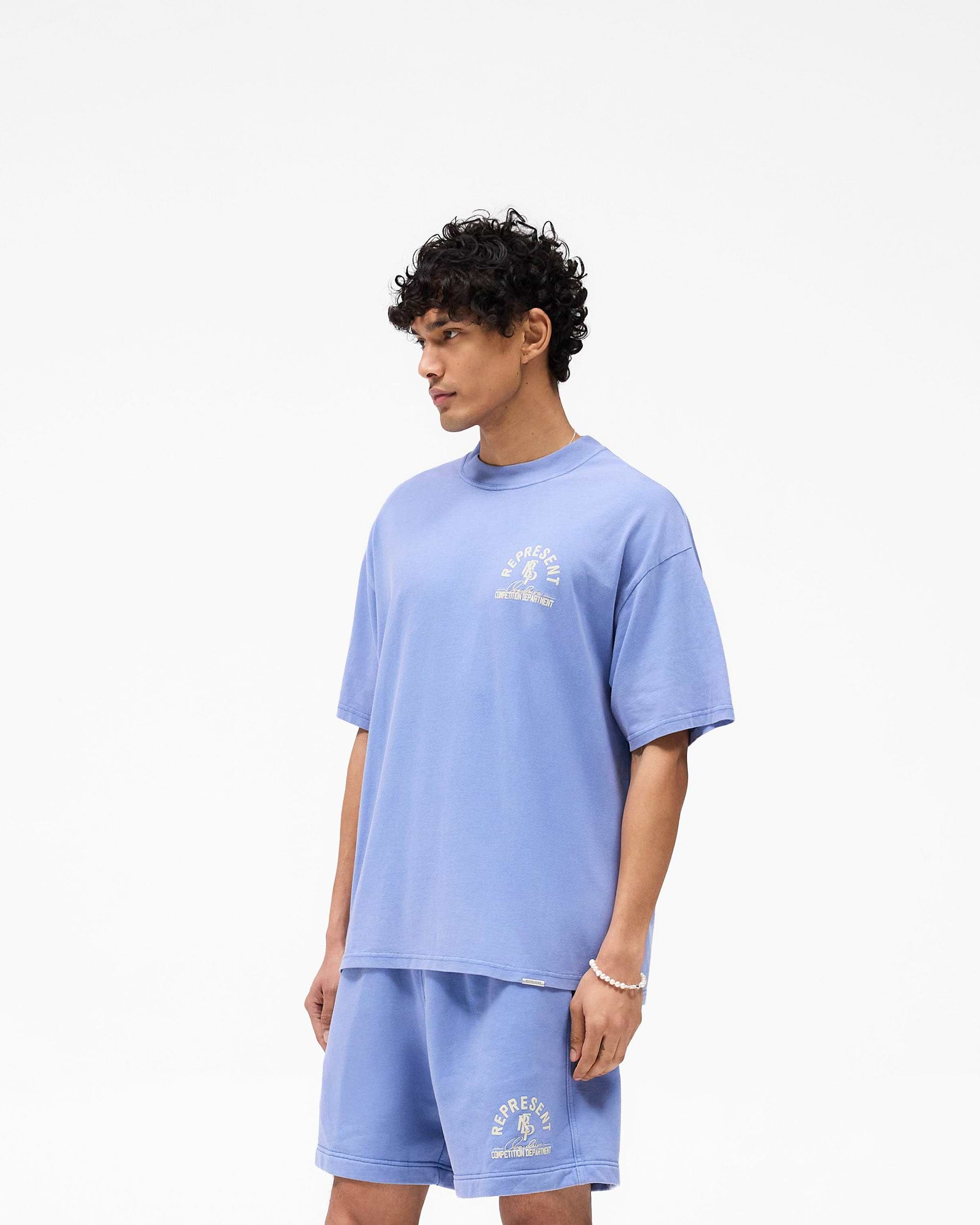 Back product image of a mens blue t-shirt on a plain white background | Competition Department T-Shirt in Bright Blue | Oversized t-shirt with raw-edge hem and graphic details | SS25 T-Shirts | Represent Clo