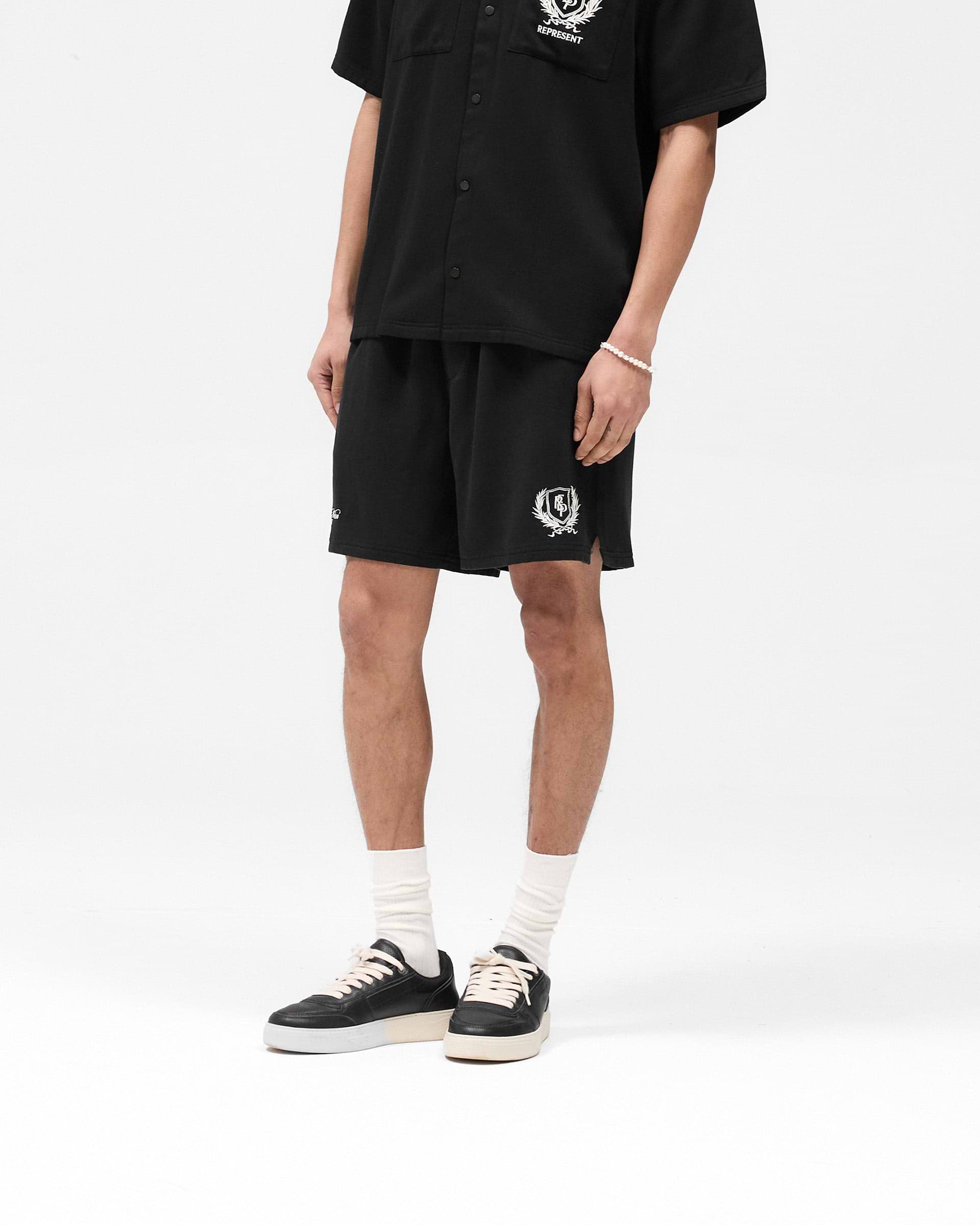 Back product image of mens black shorts on a plain white background | Represent Crest Short in Jet Black | Shorts with elasticated waistband and crest embroidery | SS25 Shorts | Represent Clo