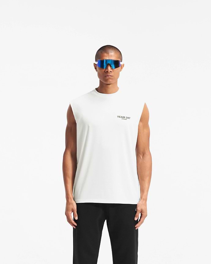 Man wearing an oversized white tank on a plain white background | Team 247 Oversized Tank in Flat White | Lightweight breathable tank top | 247 T-Shirts | Represent Clo
