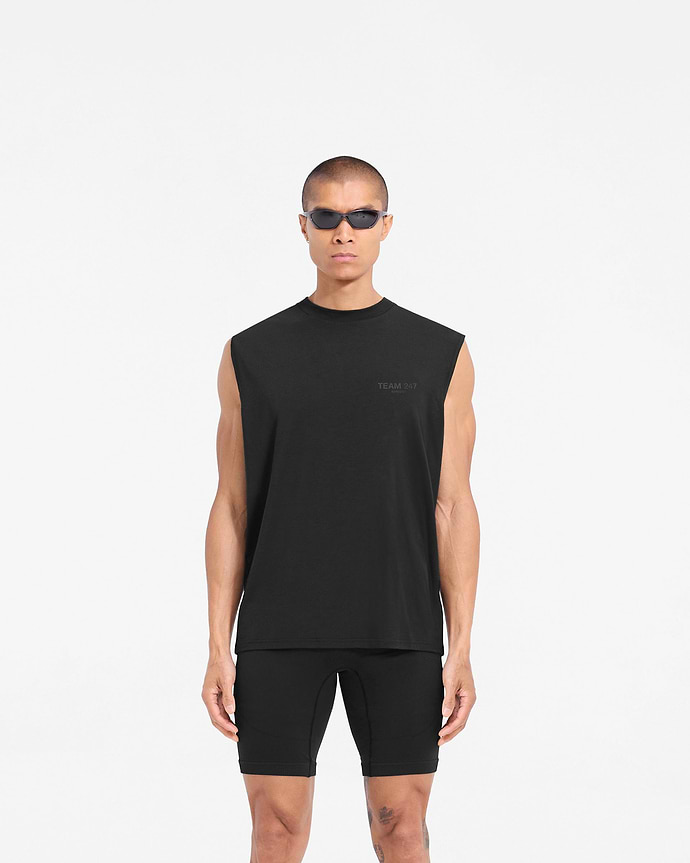 Man wearing a black oversized tank on a plain white background | Team 247 Oversized Tank in Matte Black | Lightweight breathable tank top with 4-way stretch | 247 T-Shirts | Represent Clo