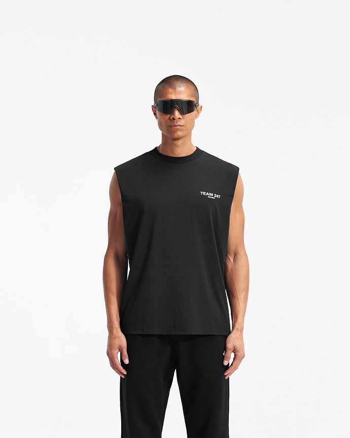 Man wearing a black tank top on a plain white background | Team 247 Oversized Tank in Black | Oversized tank top with 4-way stretch and Team 247 branding | 247 T-Shirts | Represent Clo