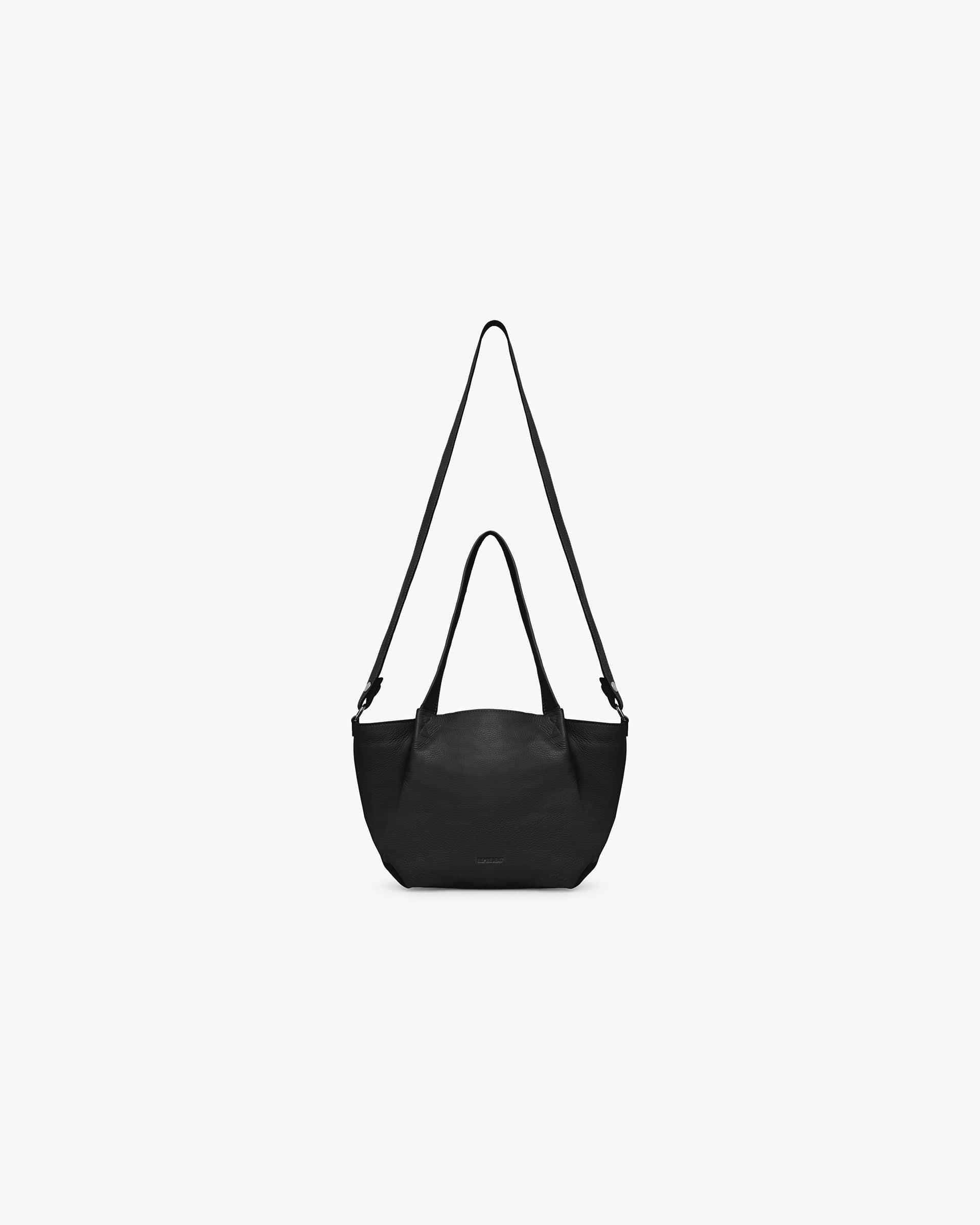 Front product image of a womens black mini tote bag on a plain white background | Leather Pleat Mini Tote in Jet Black | Structured leather mini tote with pleat detailing | Womens SS25 Accessories | Represent Clo