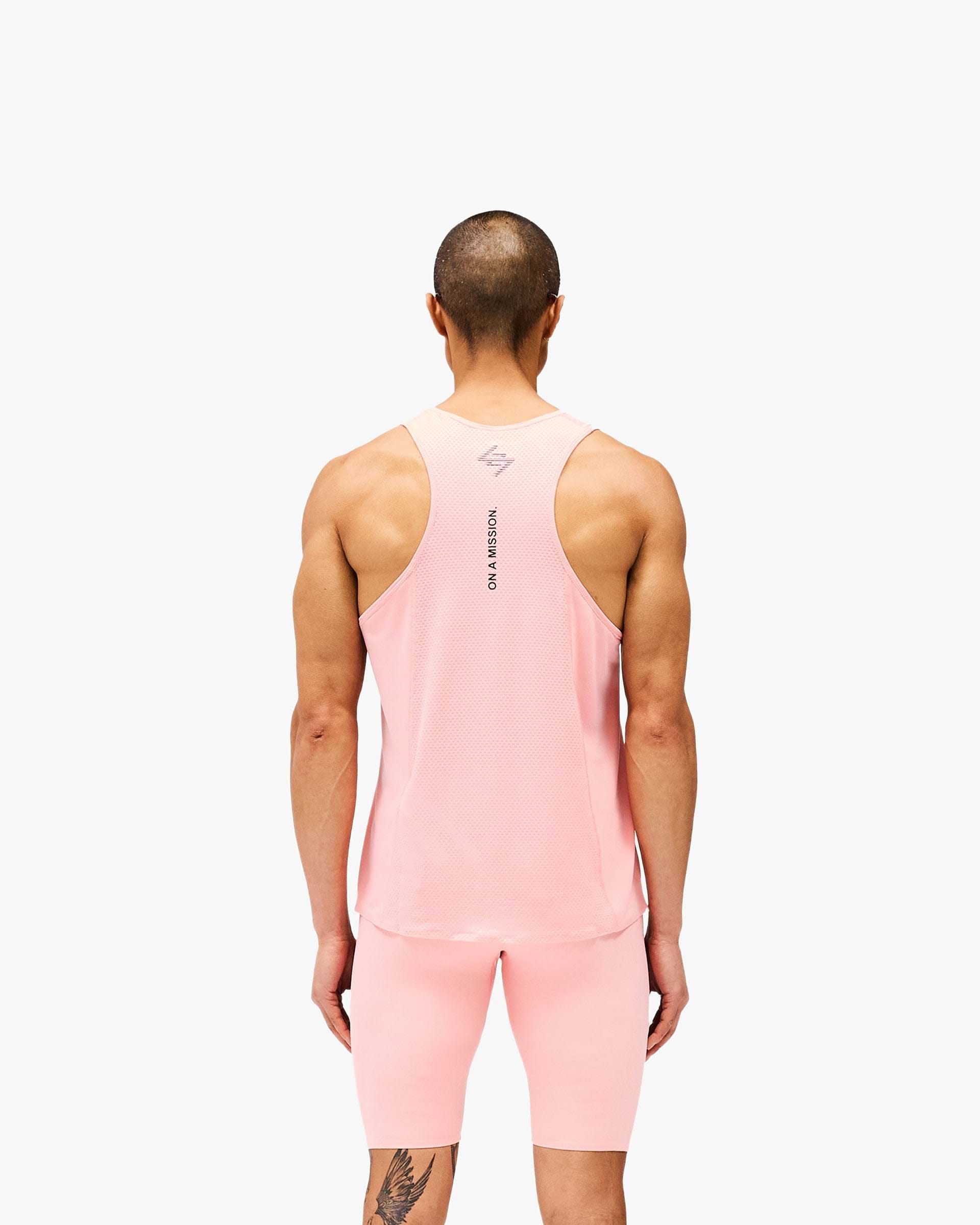 Man wearing a pink singlet on a plain white background | 247 Los Angeles Singlet in Pink | Lightweight racerback singlet with honeycomb mesh back | 247 T-Shirts | Represent Clo
