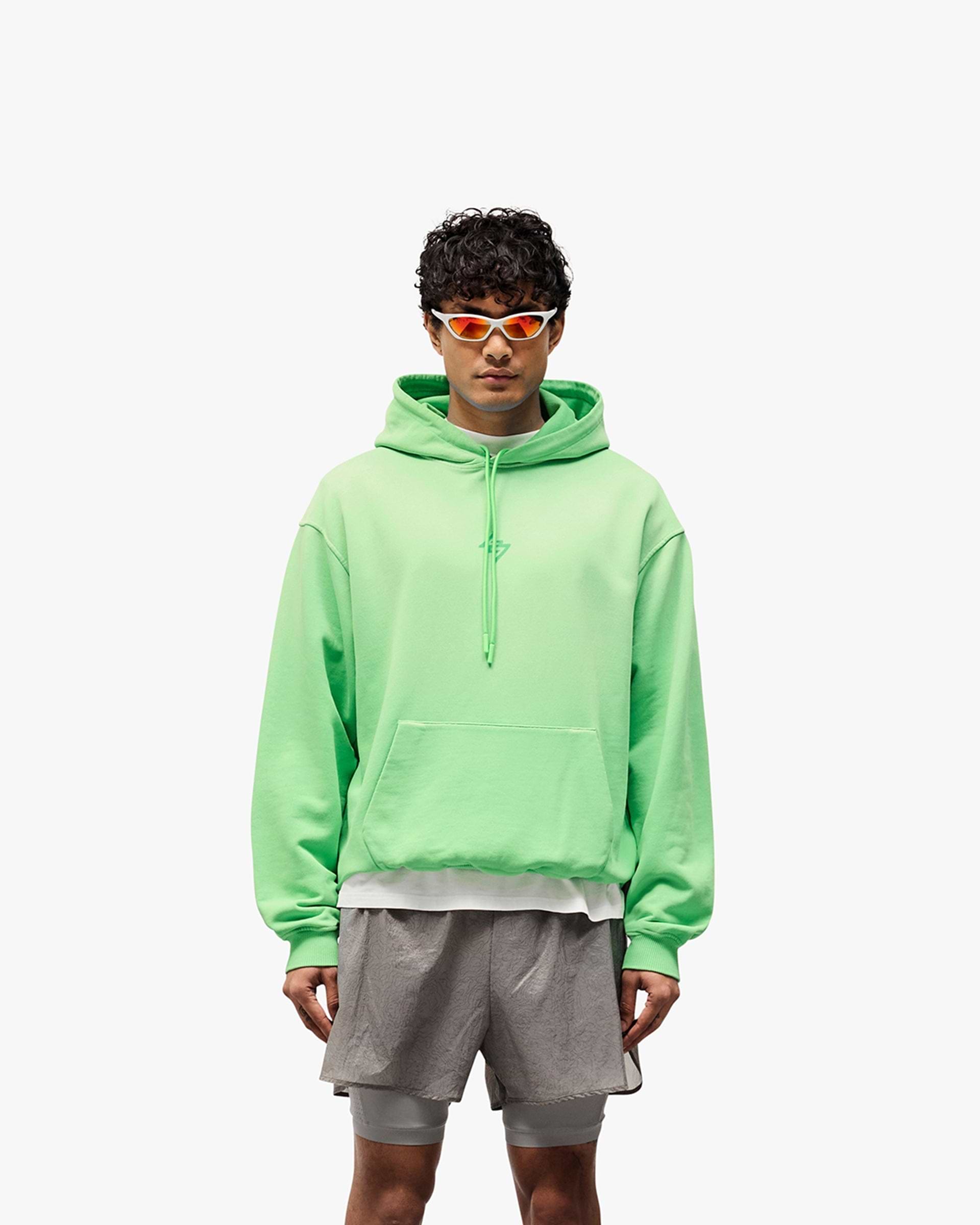 Man wearing an oversized green hoodie on a plain white background | 247 Motion Oversized Hoodie in Speed Green | Oversized hoodie with ribbed hem and cuffs | 247 Hoodies | Represent Clo