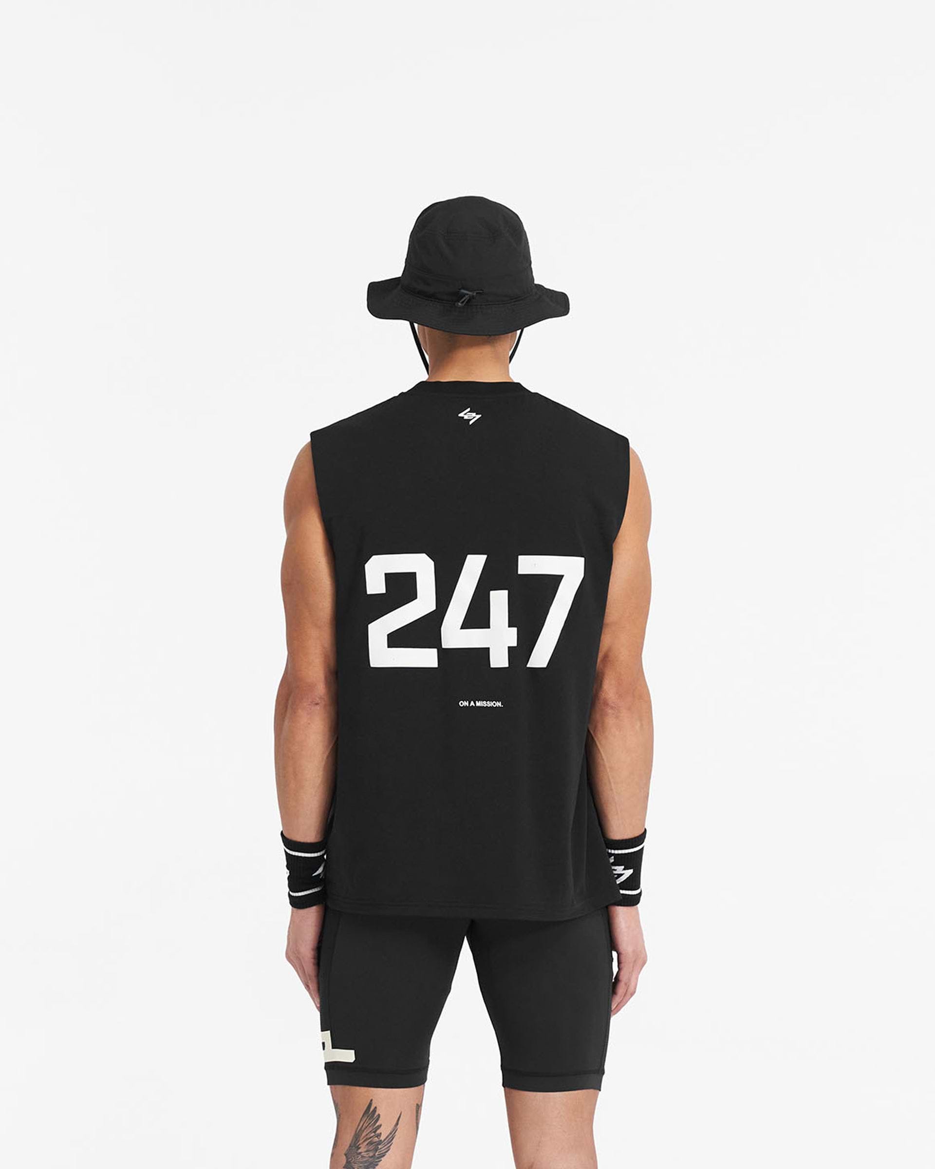 Man wearing a black oversized tank top on a plain white background | 247 Oversized Tank in Jet Black | Lightweight breathable tank with 4-way stretch | 247 T-Shirts | Represent Clo