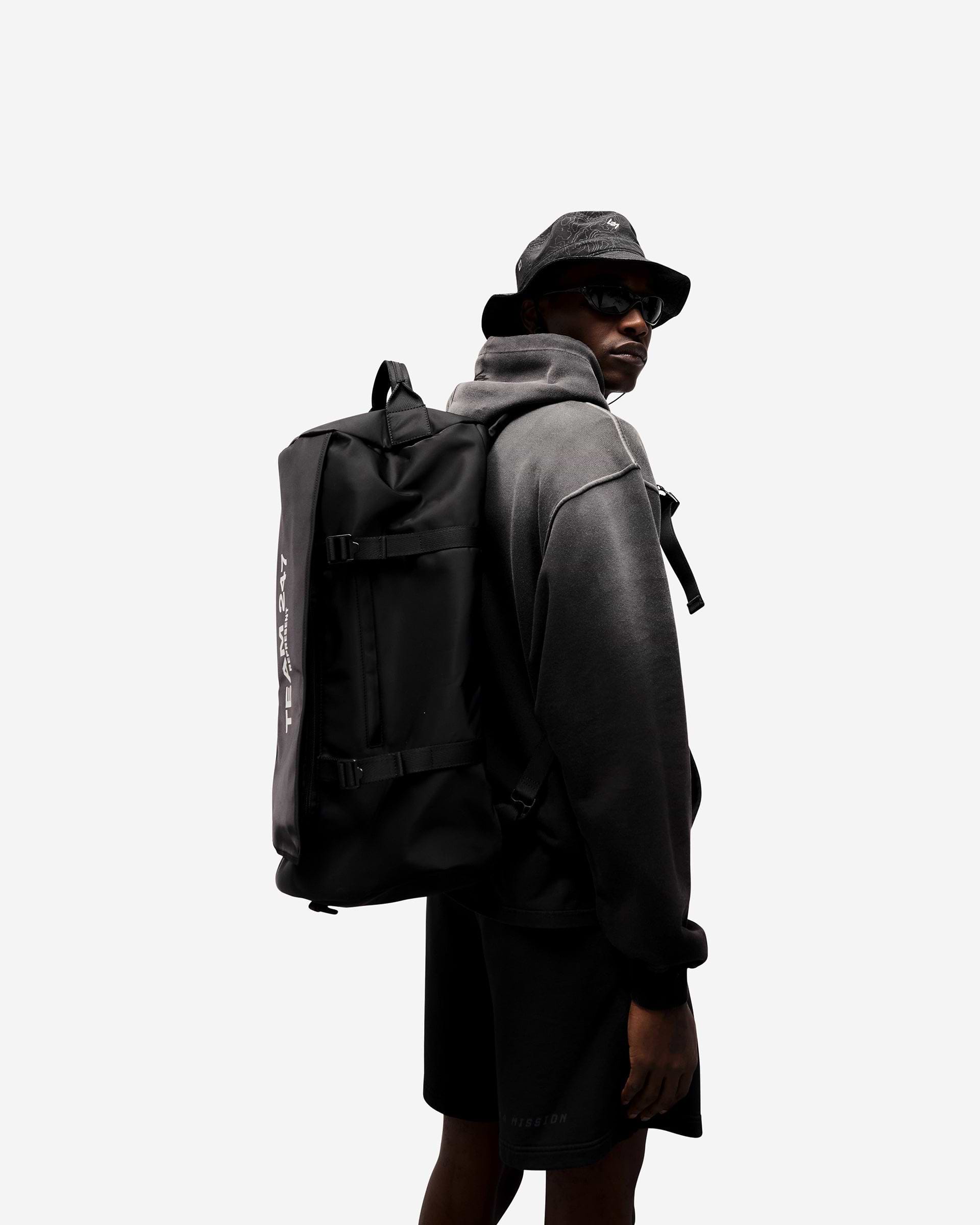 Back product image of a mens black bucket hat on a plain white background | 247 Contour Bucket Hat in Black | Ripstop fabric bucket hat with adjustable bungee and reflective design | 247 Accessories | Represent Clo