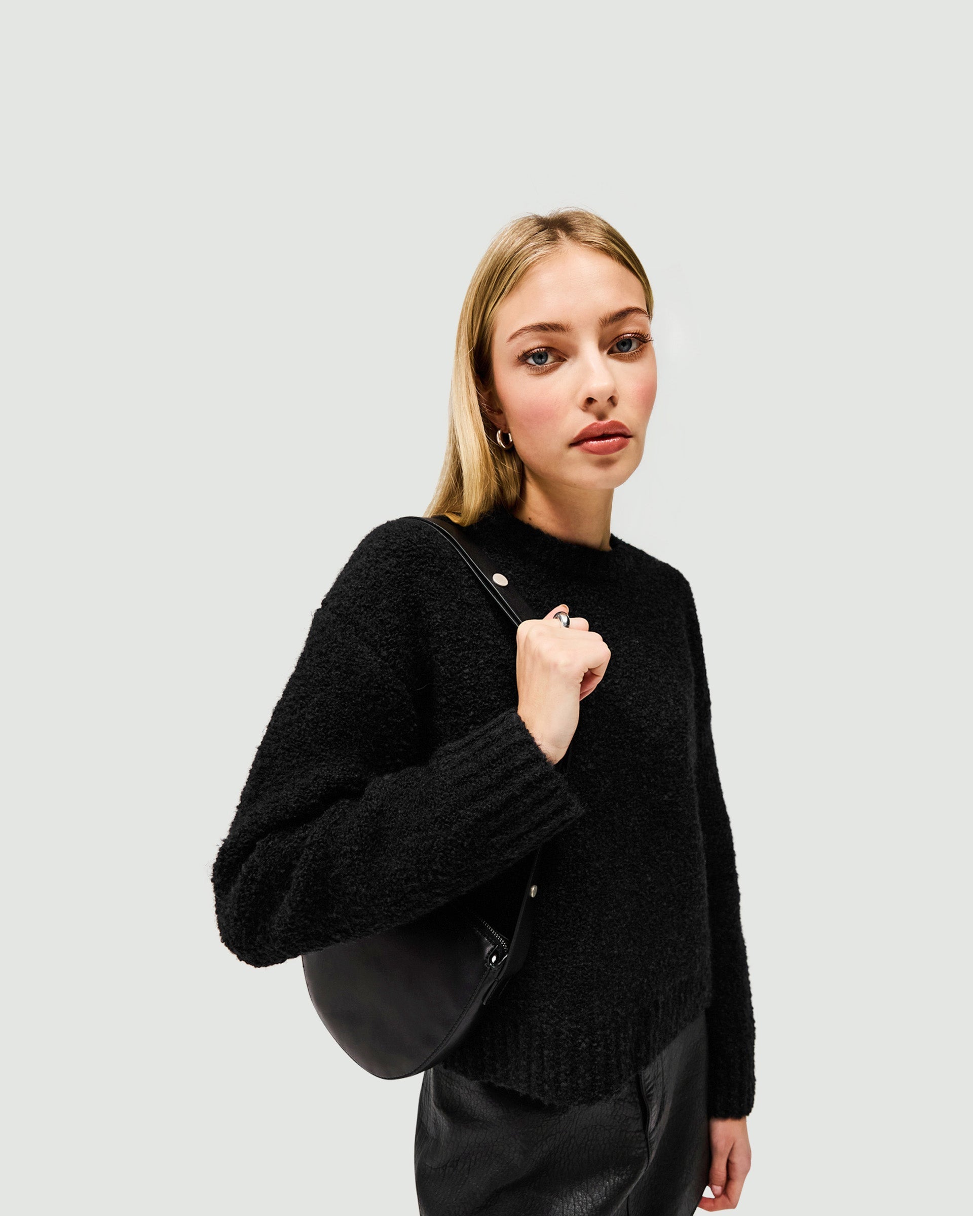 Back product image of a womens black knit sweater on a plain white background | Spin Sweater in Jet Black | Boxy knitwear with rib stitch hem and cuffs | SS25 Knitwear | Represent Clo