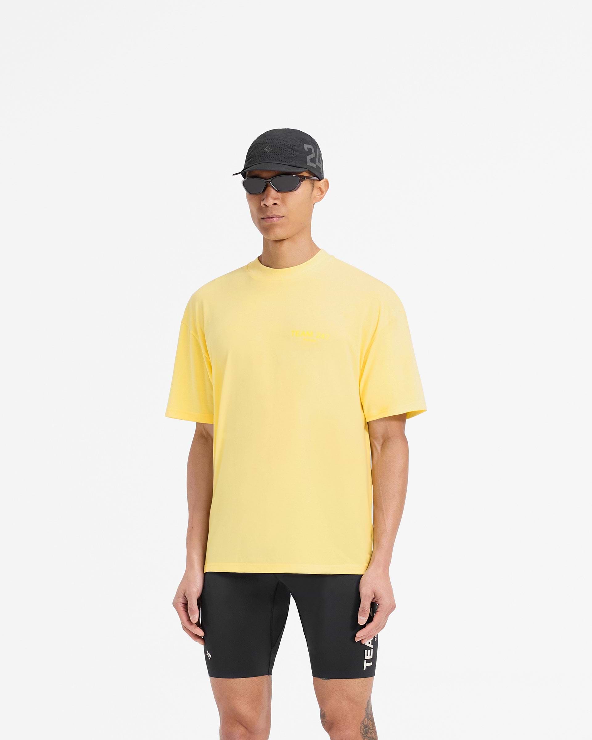 Man wearing a yellow oversized t-shirt on a plain white background | Team 247 Oversized T-Shirt in Lemon | Quick drying lightweight t-shirt | 247 T-Shirts | Represent Clo