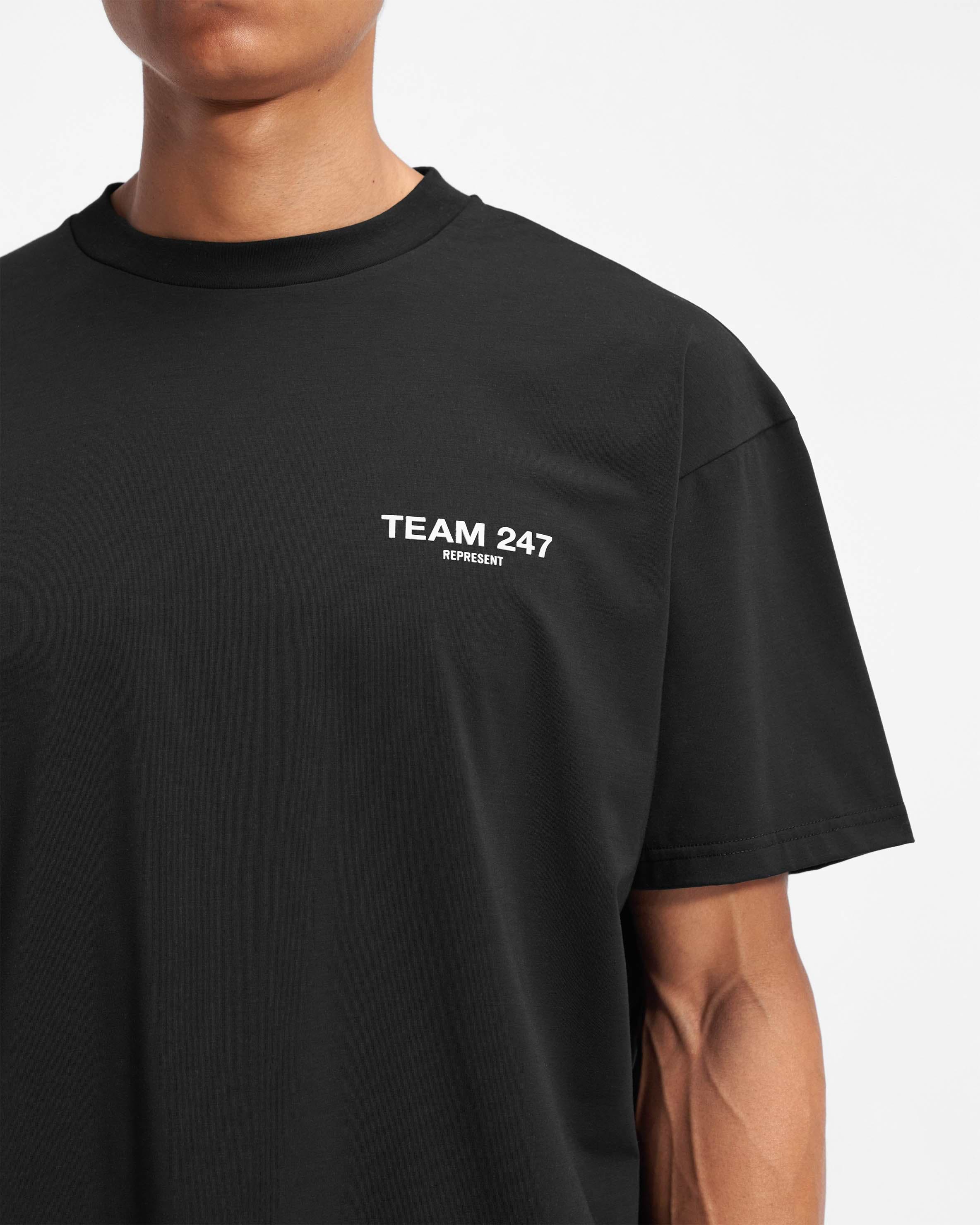 Man wearing an oversized black t-shirt on a plain white background | Team 247 Oversized T-Shirt in Black | Lightweight quick dry t-shirt | 247 T-Shirts | Represent Clo