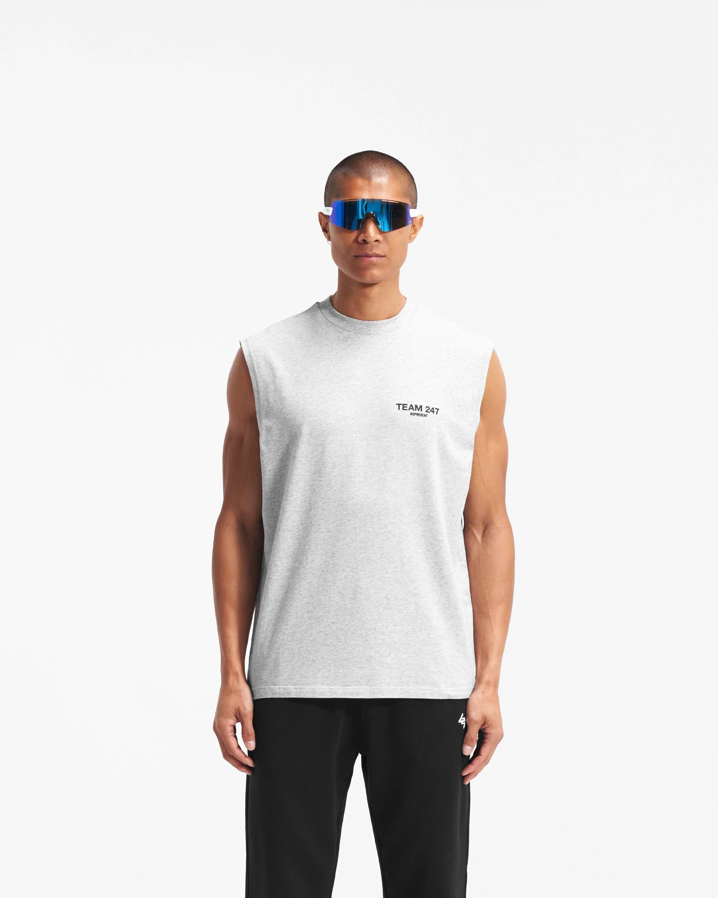 Man wearing an oversized grey tank top on a plain white background | Team 247 Oversized Tank in Ash Grey | Lightweight breathable tank with 4-way stretch | 247 T-Shirts | Represent Clo
