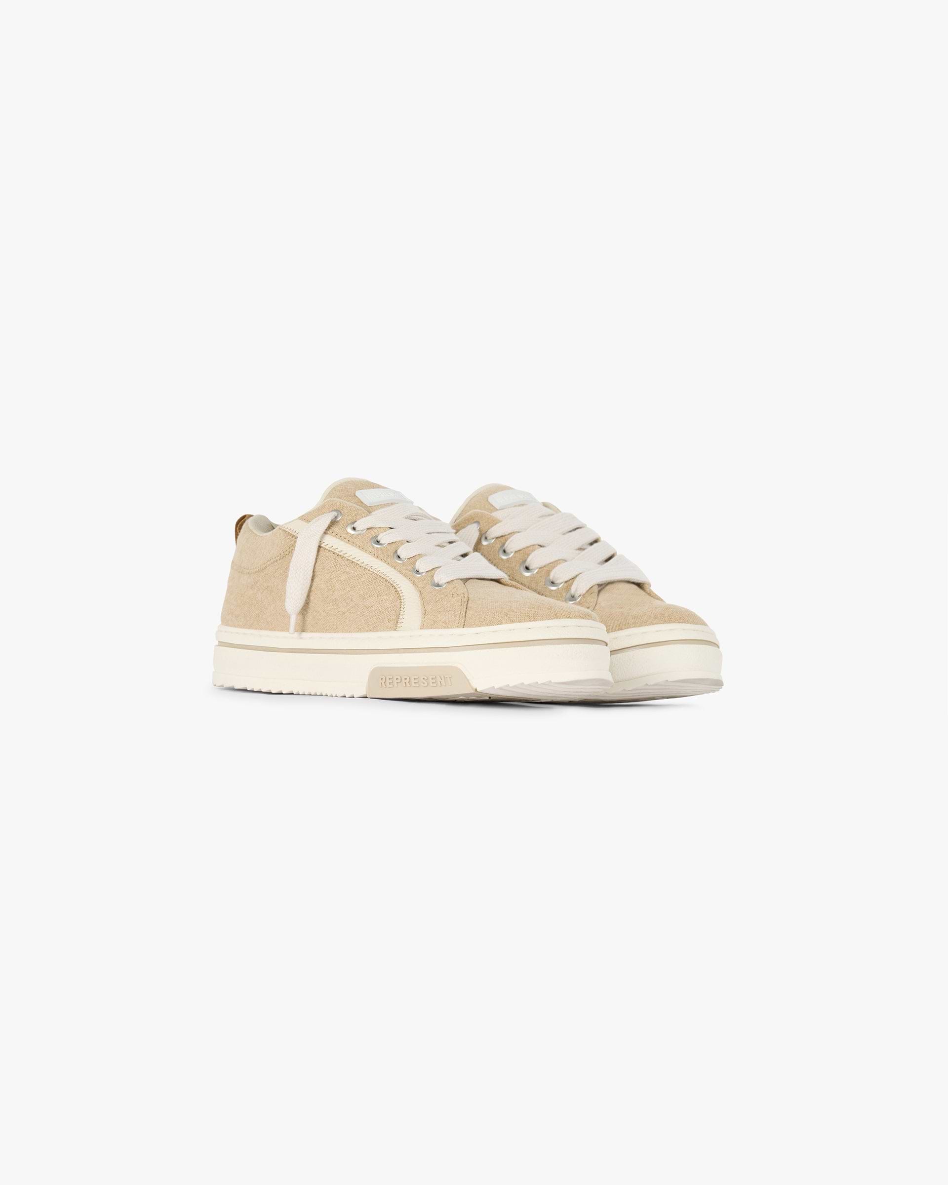 Back product image of mens brown sneaker on a plain white background | HTN Low Rustic in Latte | Low top sneaker with rustic canvas upper and tumbled leather panels | SC24 Footwear | Represent Clo